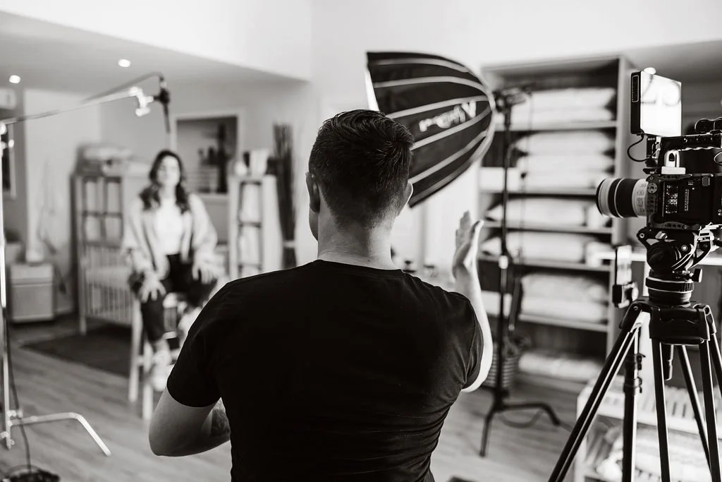 Man directs video shoot with cinema camera and lights