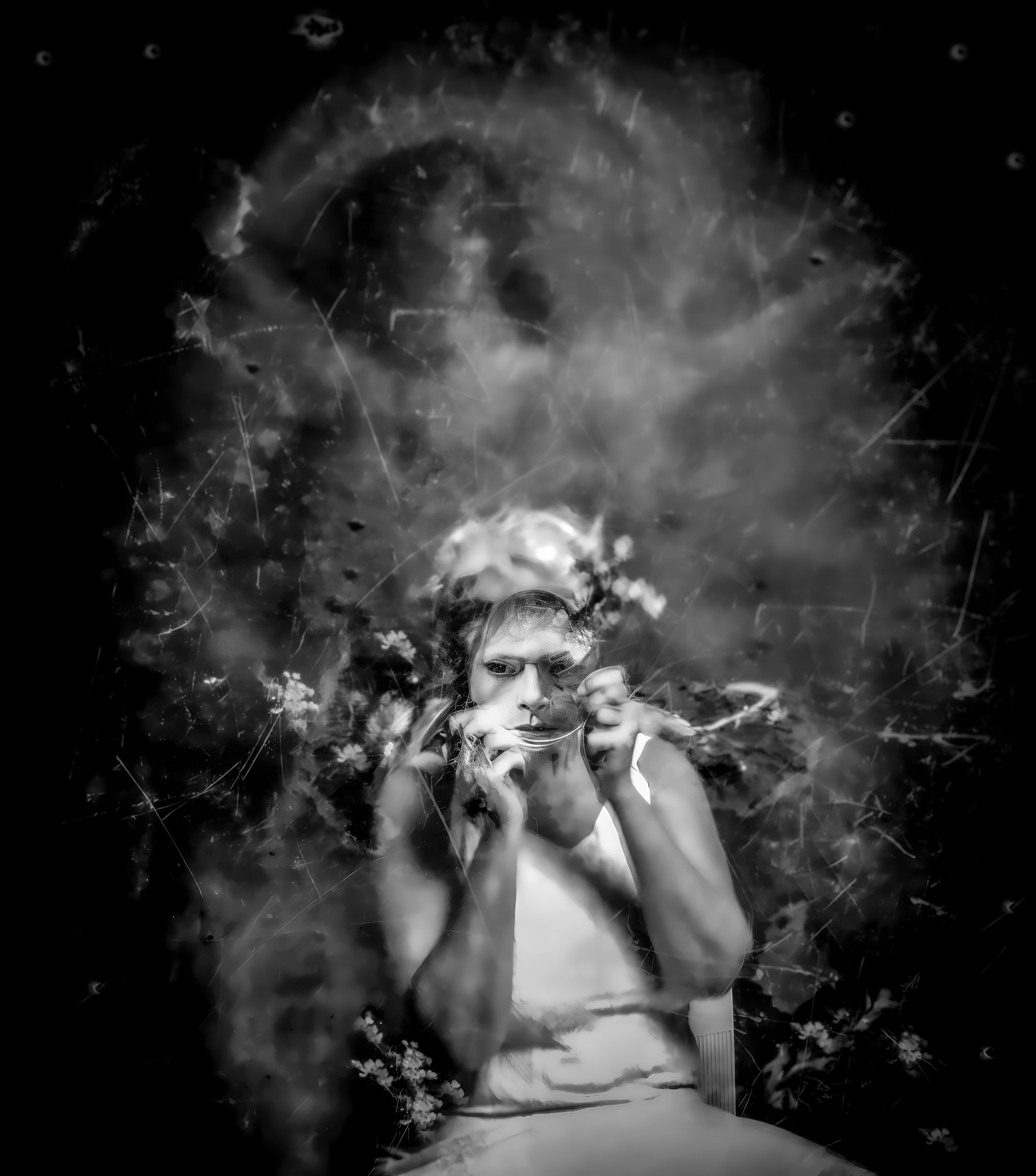 Artistic black and white portrait of a person in a ghostly atmosphere, surrounded by abstract patterns and textures.