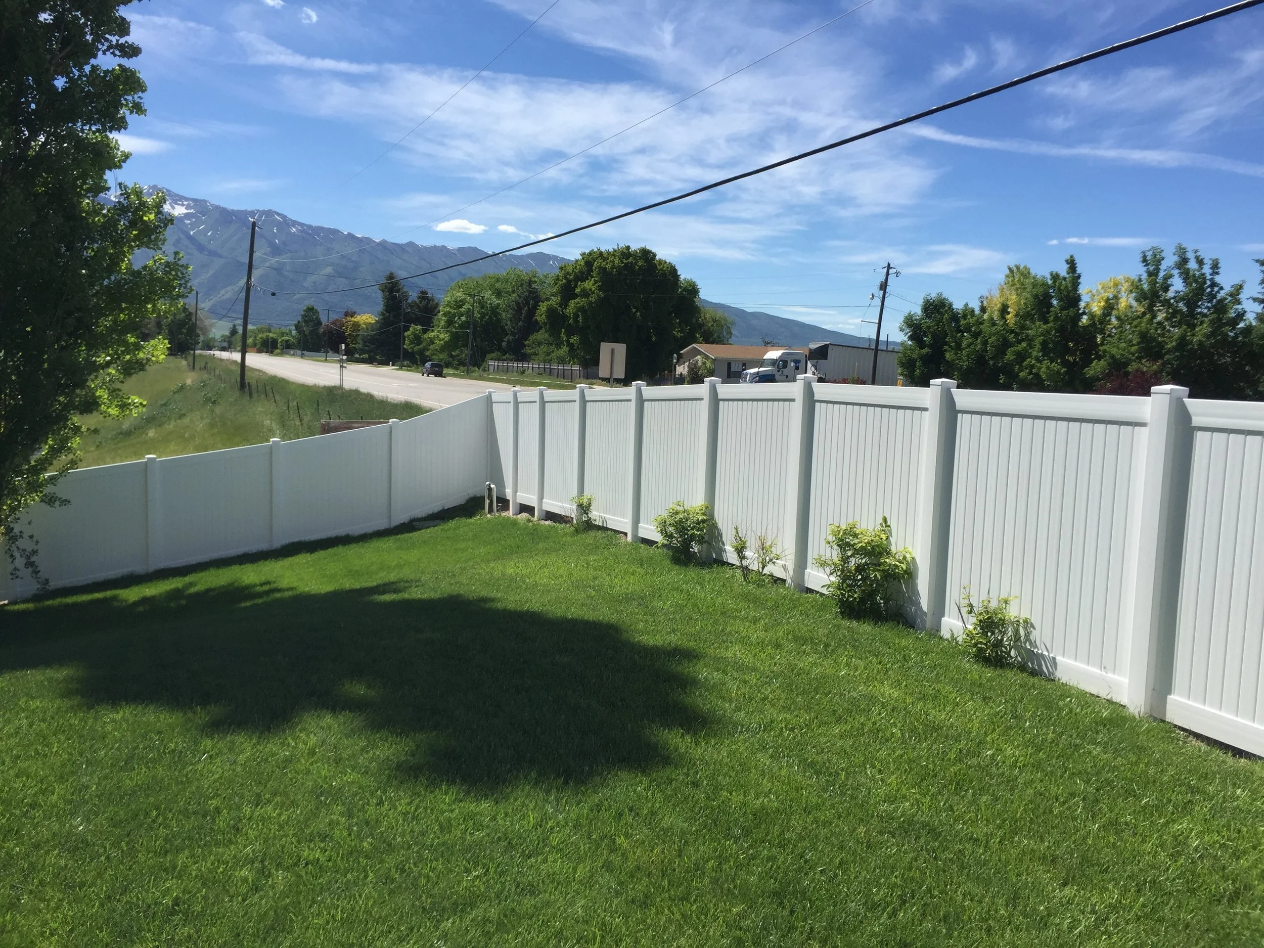 Backyard with white vinyl fence in Hyrum, UT.