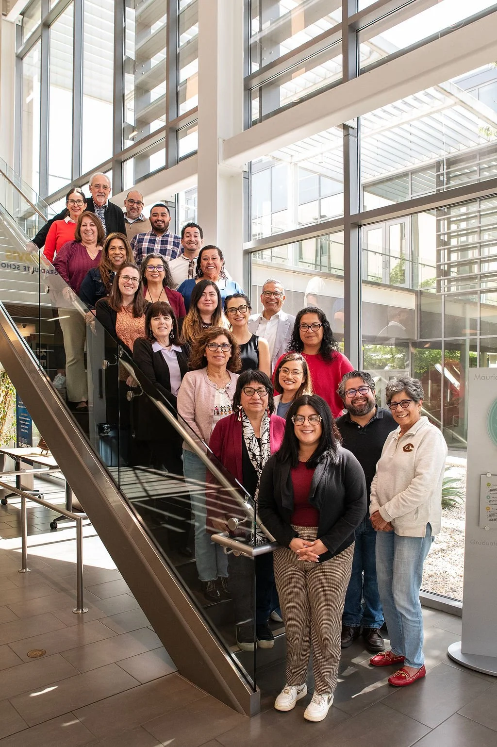 2026 NEA Cohort posing for a photo staggered on a Stairway