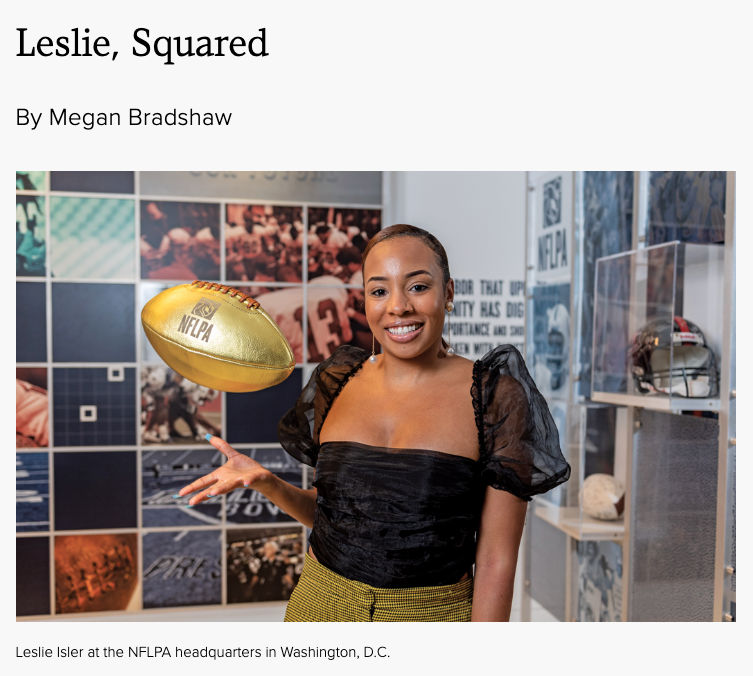 Leslie Isler at the NFLPA headquarters in Washington, D.C., smiling and holding a gold football.