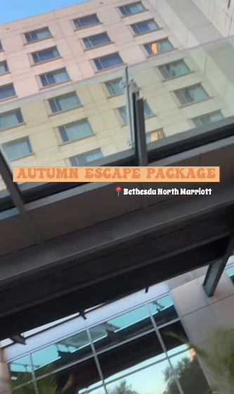 A view of glass windows and a building reflecting in the glass, with an orange banner that reads 'Autumn Escape Package' and a white label for 'Bethesda North Marriott'.