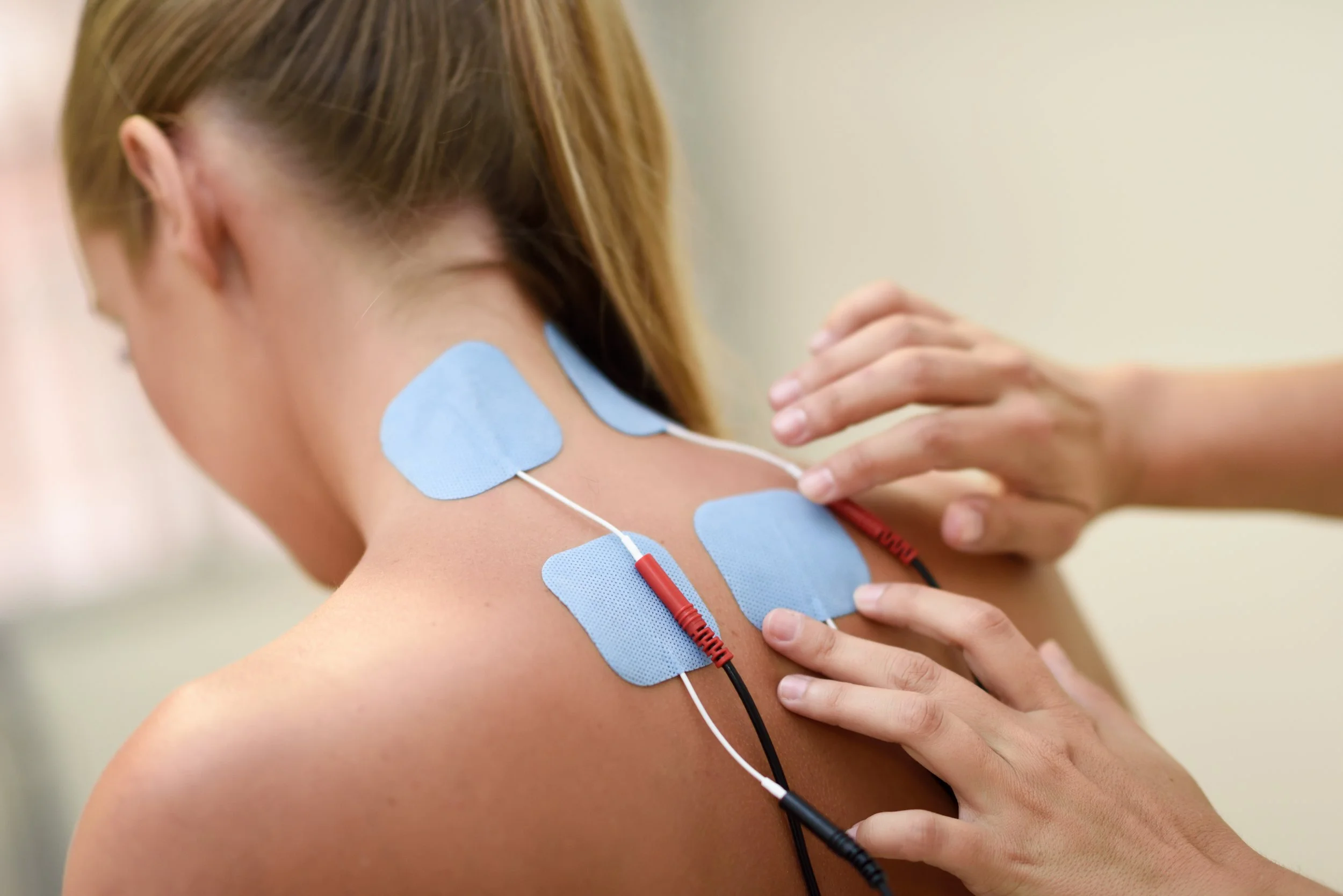 woman getting electrical stimulation therapy on her back