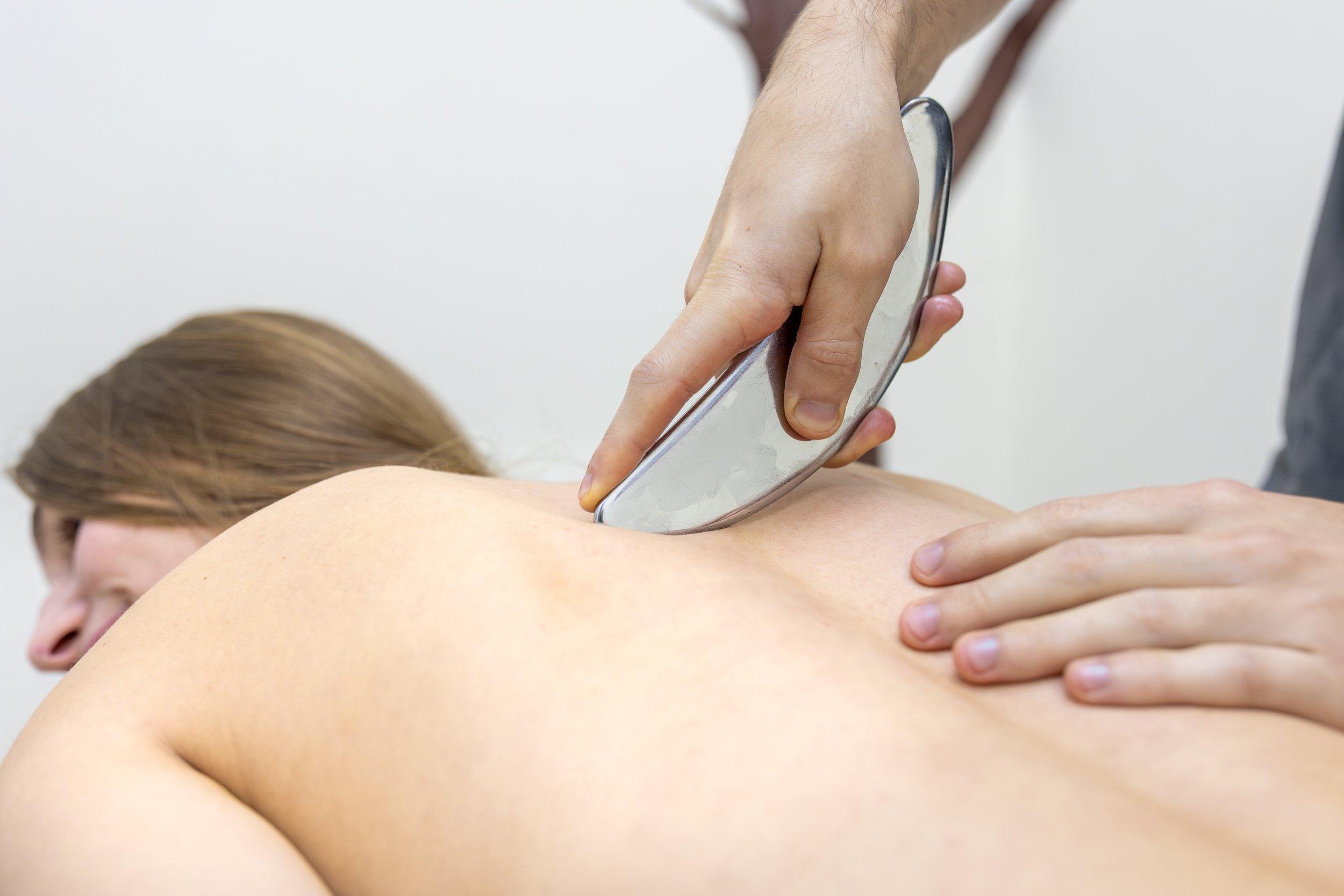 woman getting Graston Technique done on her back