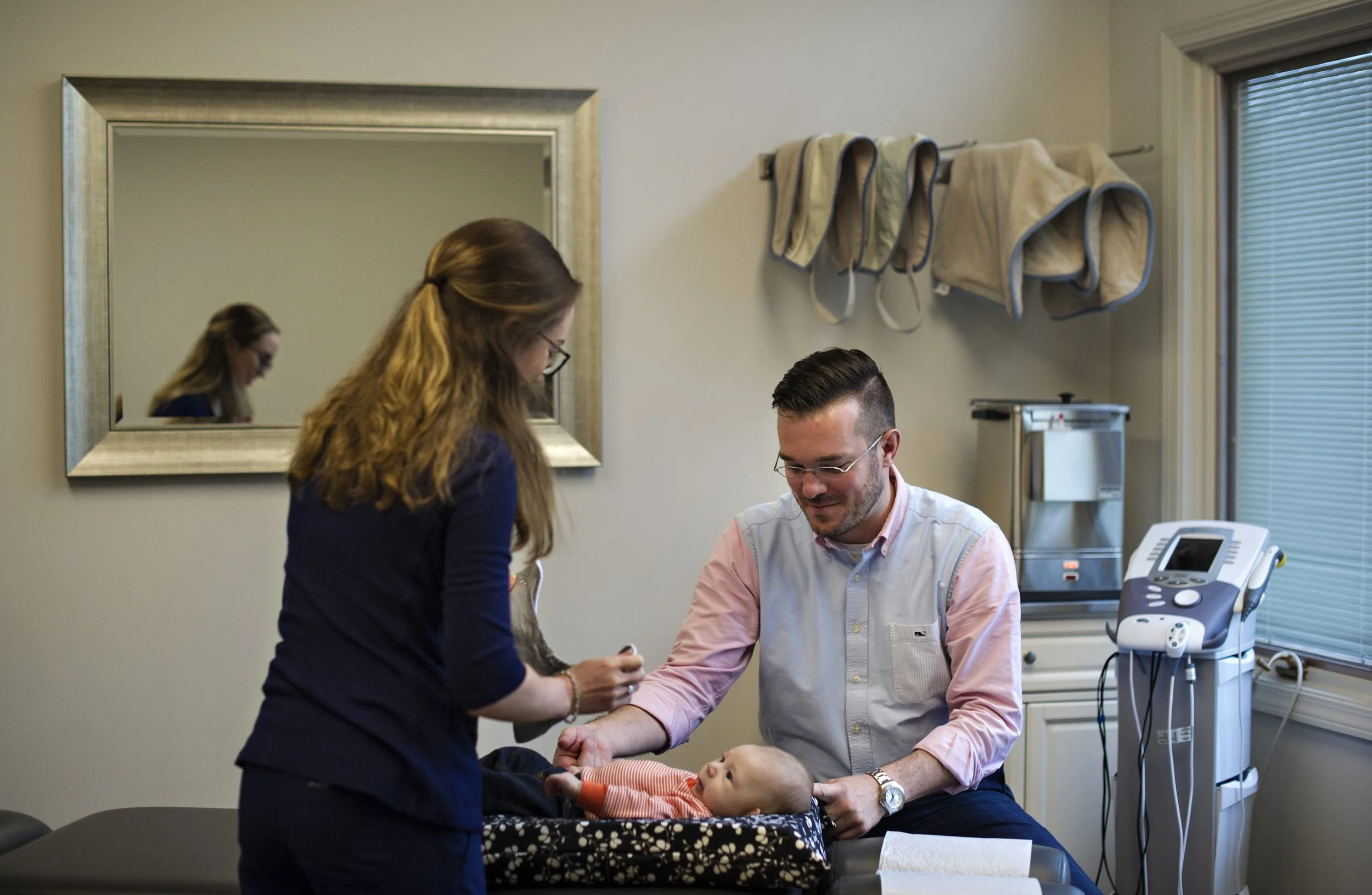 Dr. Swinton treating an infant on a chiropractic table