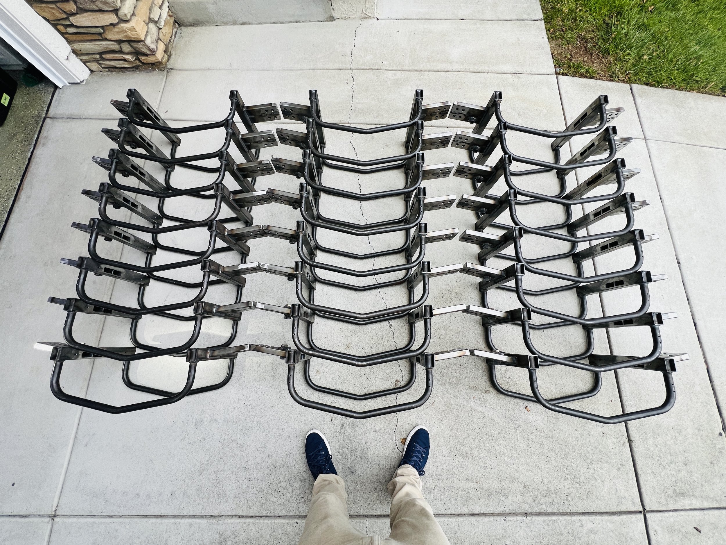 Several Griffin Motorsports impact frames outside on a concrete walkway.