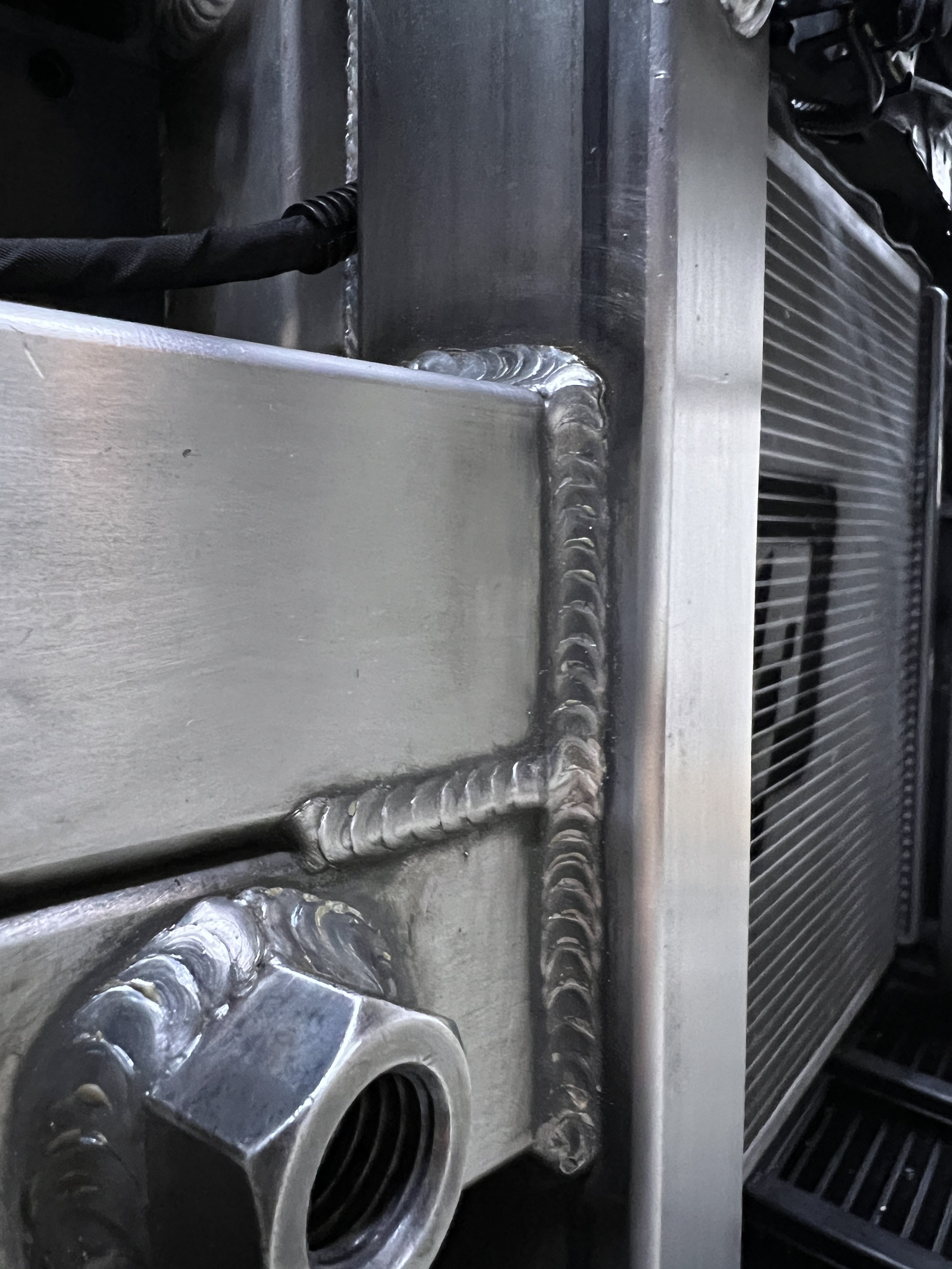 A welded, silver metal surface.