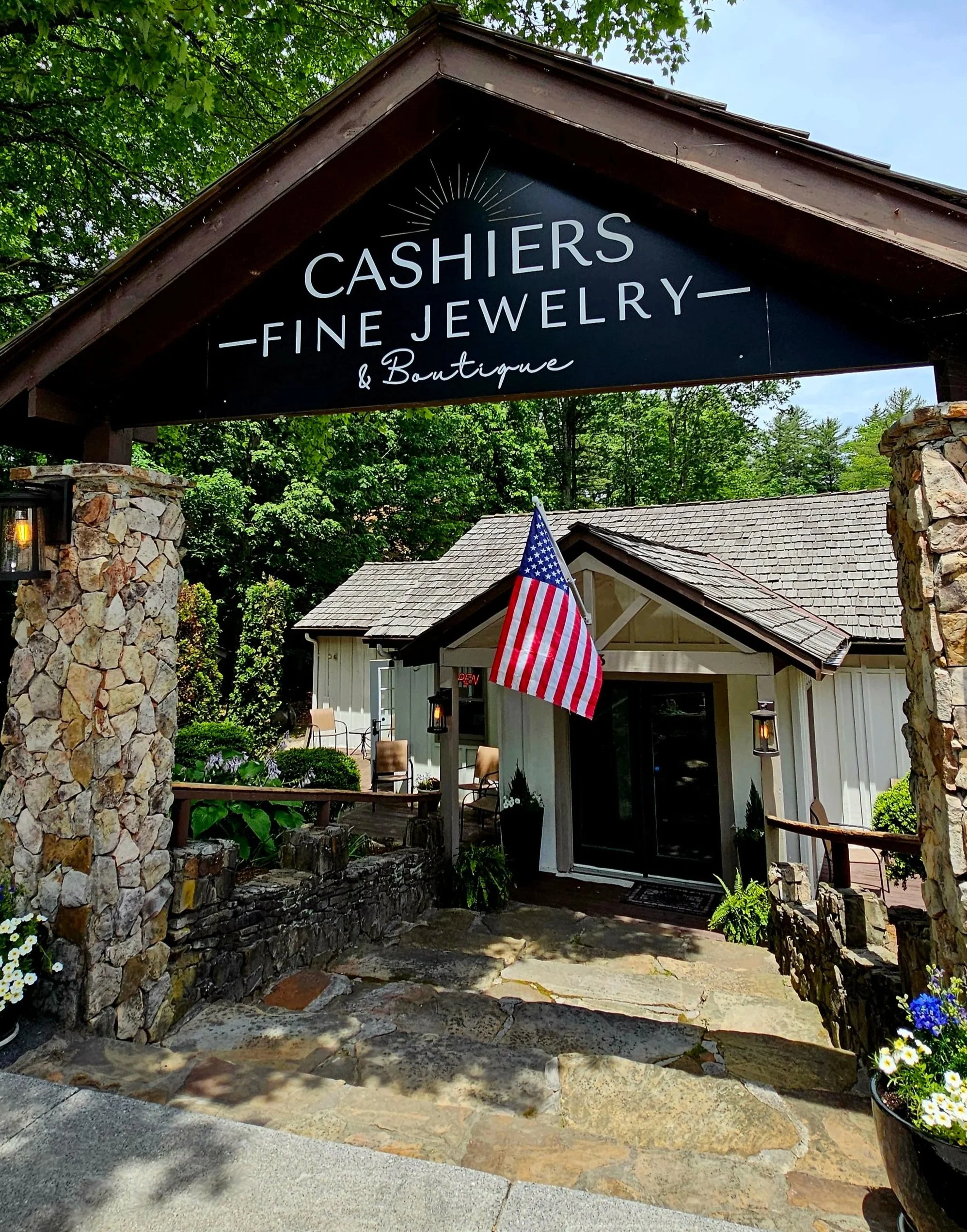 Street view of Cashiers Fine Jewelry showing the sign and an American Flag
