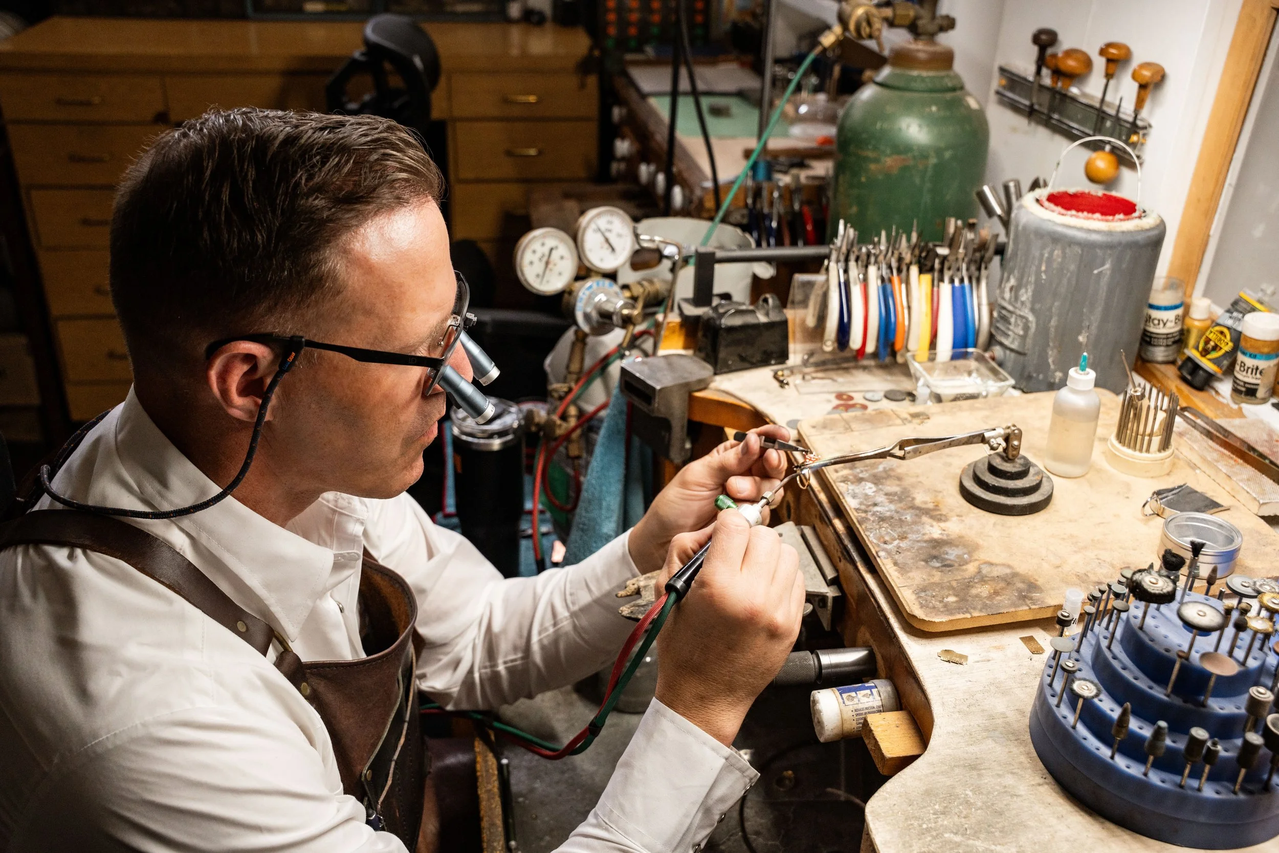 Buddy Driggers working at jewelry bench repairing  and using tools