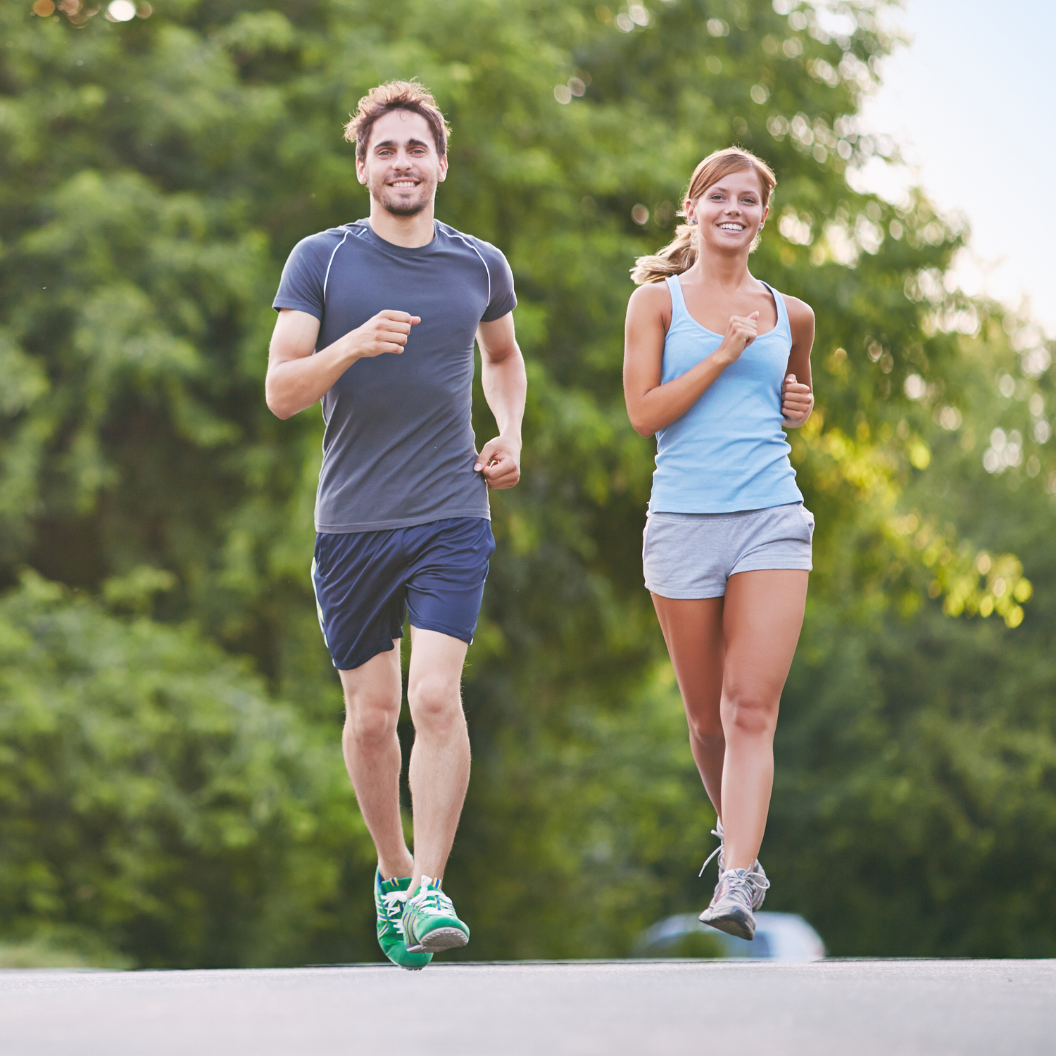 Couple running together outdoors on a sunny day