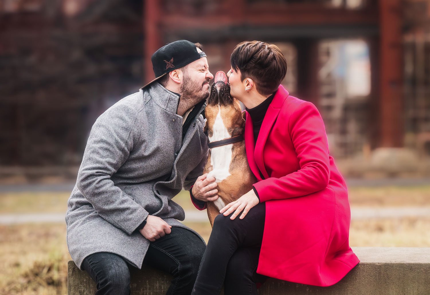 Ein paar genießt einen besonders innigen Moment mit ihrem Hund während eines Outdoor Fotoshootings für Hundebesitzer