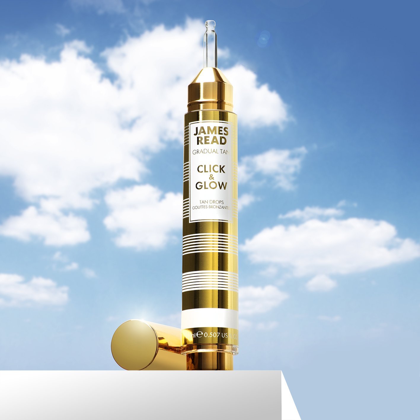 Creative product shot against a blue sky background for James Read tanning product by Shutters Photography London