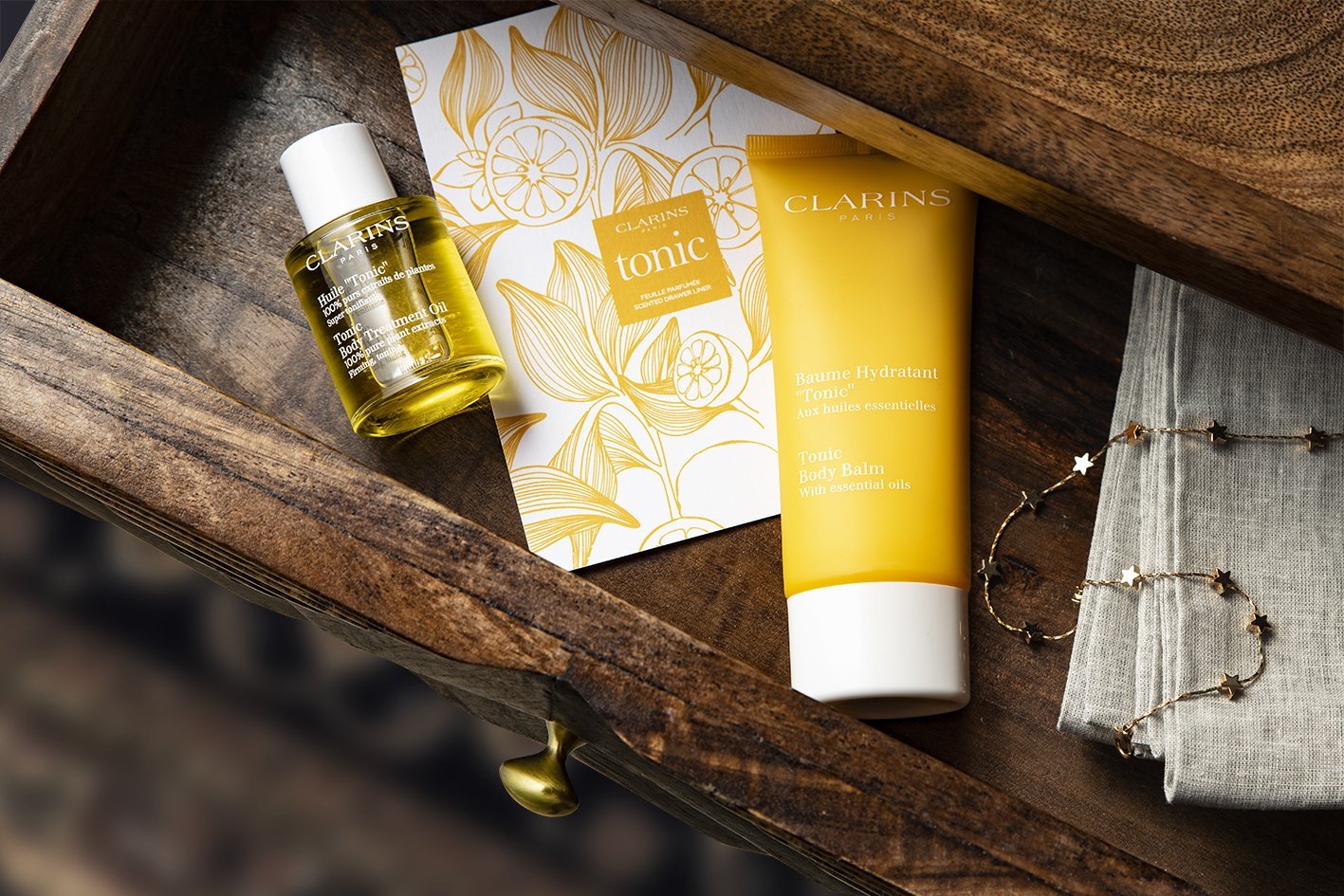 A bedside drawer containing treats from Clarins, a Relax oil and lotion as well as a fragrant drawer liner.