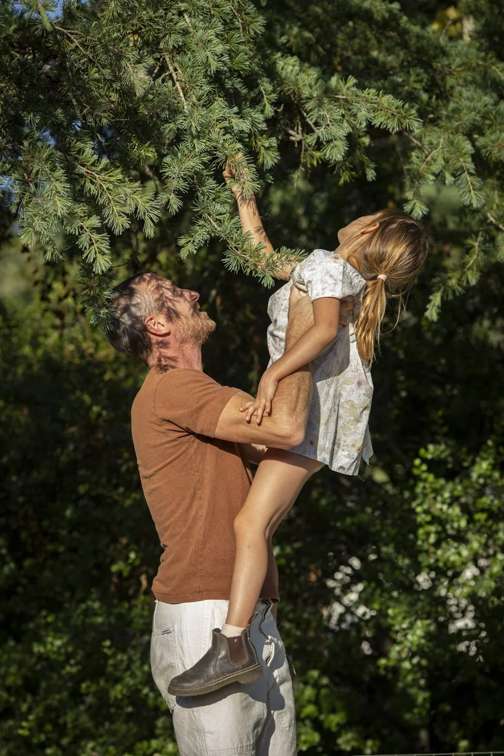Father holding his daughter in the garden during a family photography session in Ojai