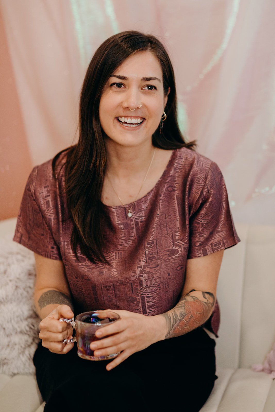 Dr. Midori Barker, ND sitting with a cup of tea and smiling