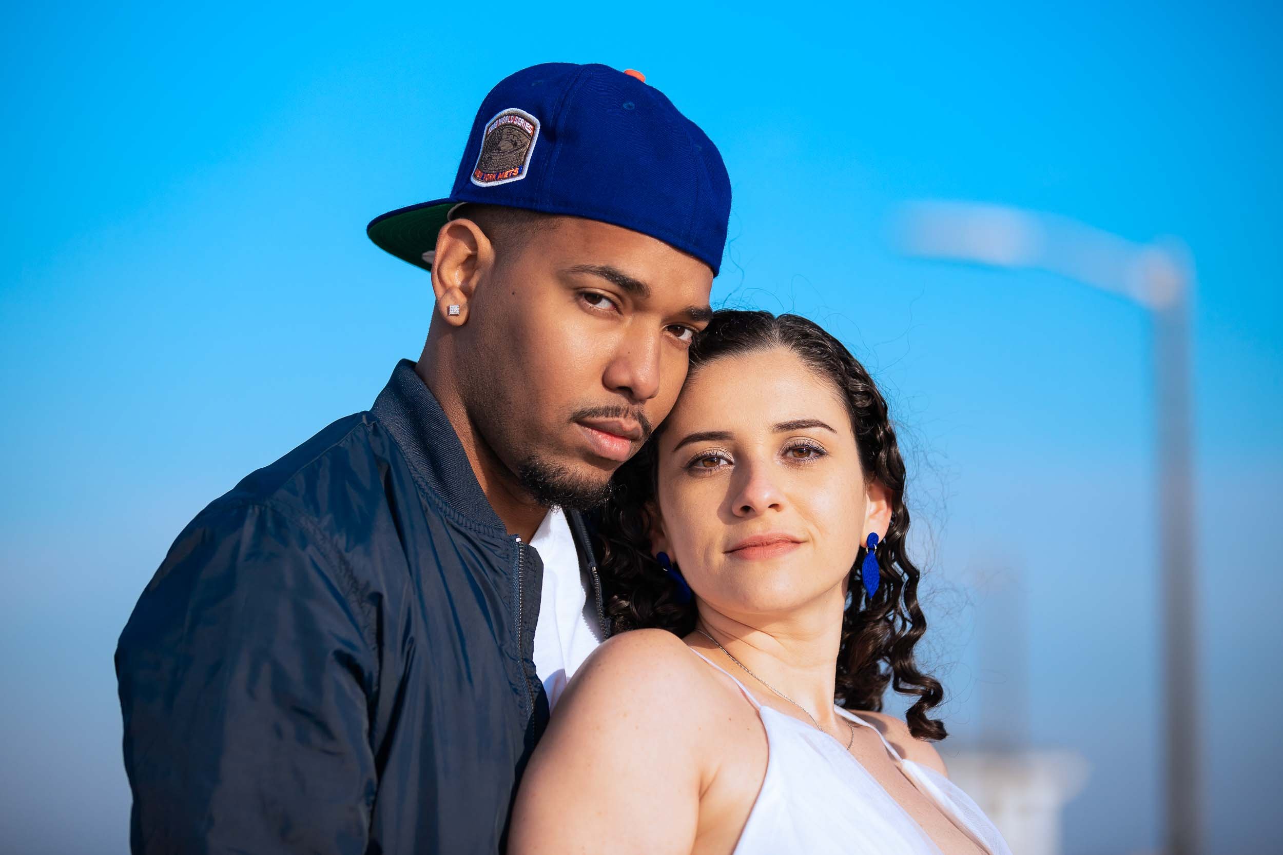 Romantic couples portrait session at Ballast Point Park in Tampa featuring a stylish couple photographed outdoors during golden hour with soft natural light and a waterfront atmosphere.