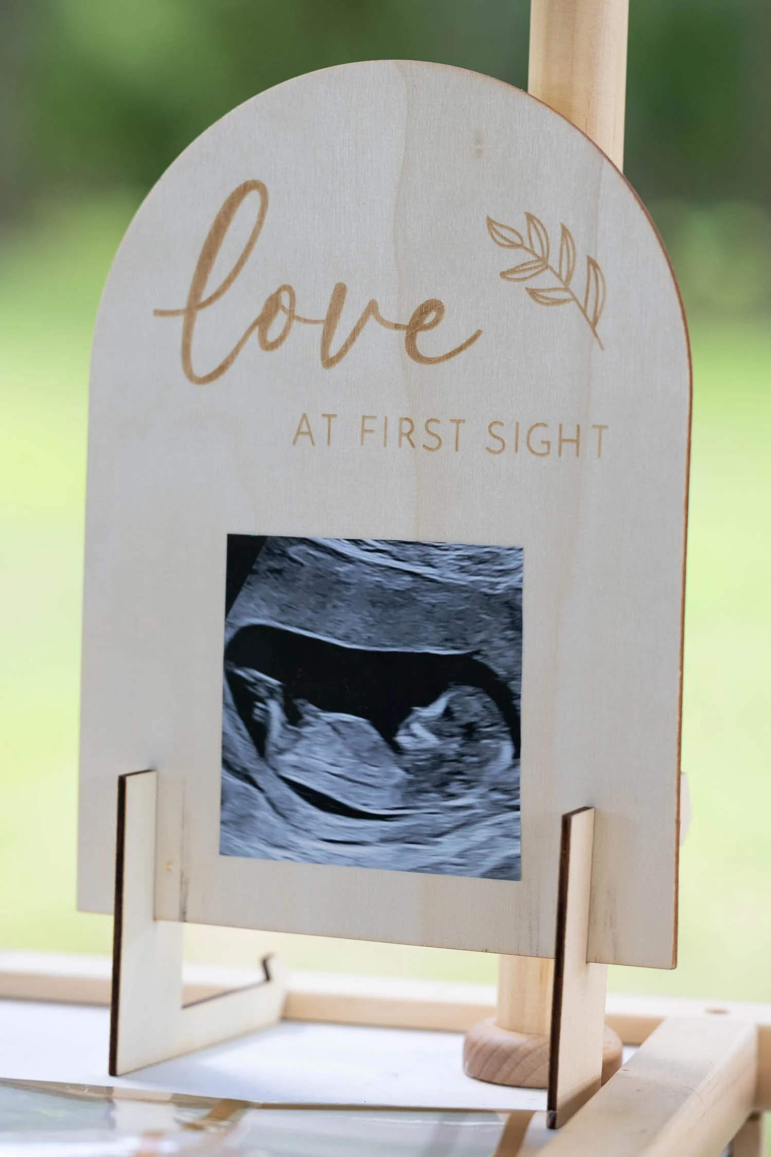 Baby shower ultrasound display sign with floral-inspired design photographed by a Tampa baby shower photographer, JMC Innovations.