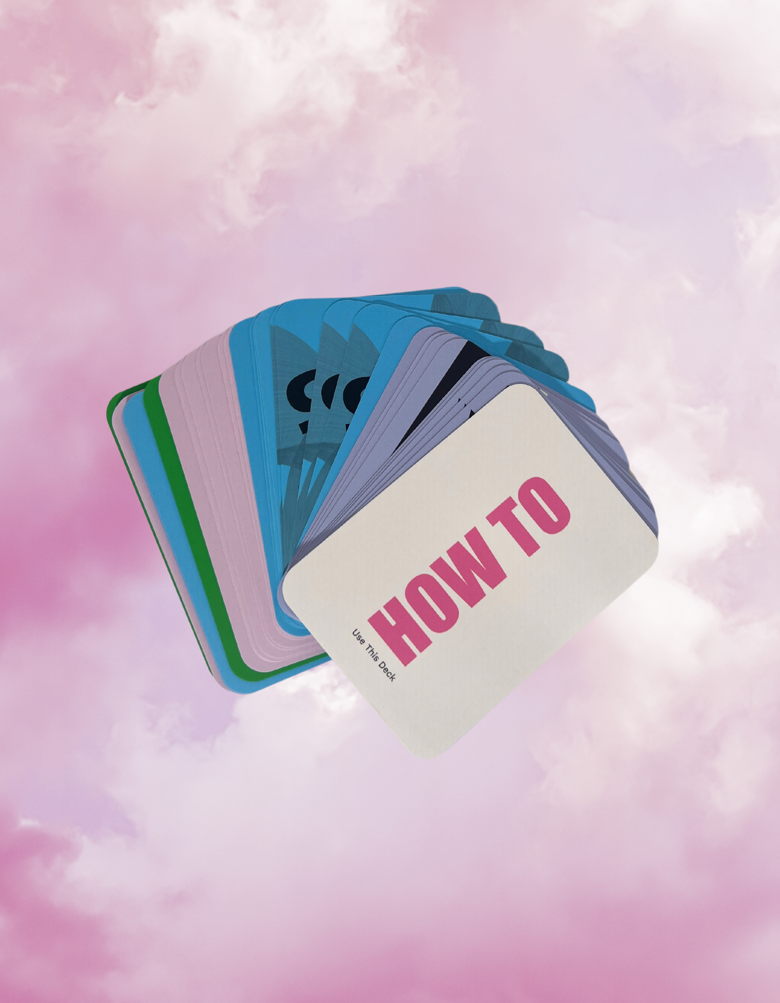 A deck of cards floating in the sky with pink clouds, featuring cards labeled 'HOW TO' and 'Use This Deck'.