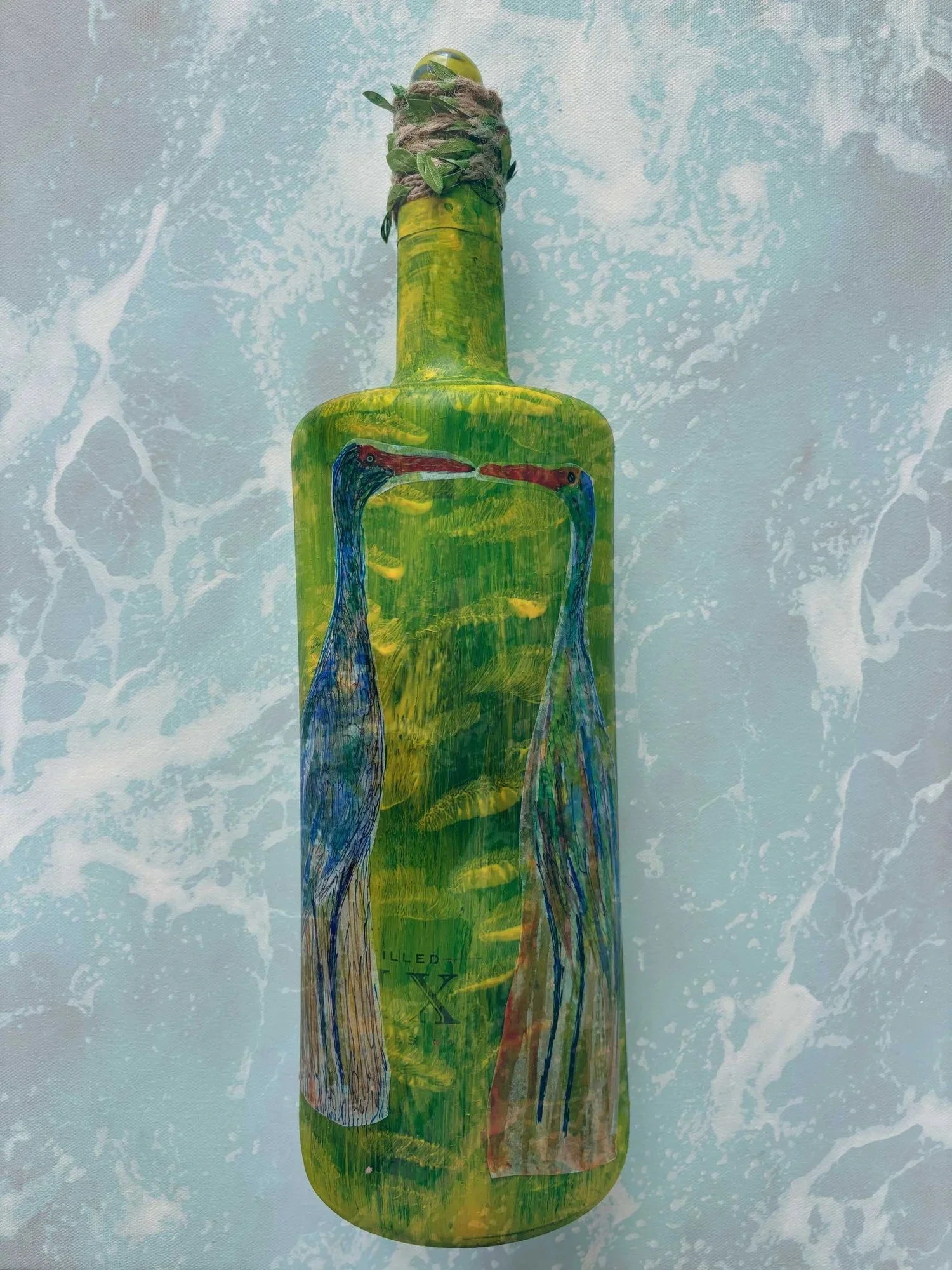 green-bottle-with-bird-artwork.jpeg
