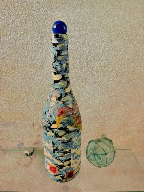 bottle-with-blue-brushstrokes-and-bird-artwork.jpeg