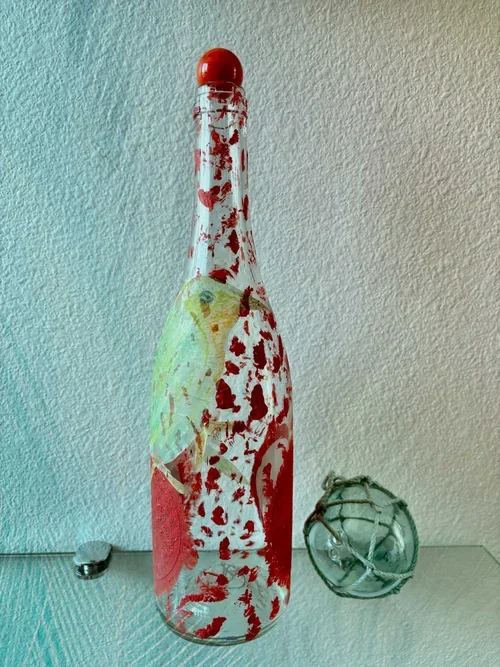red-and-white-bottle-with-bird-artwork.webp