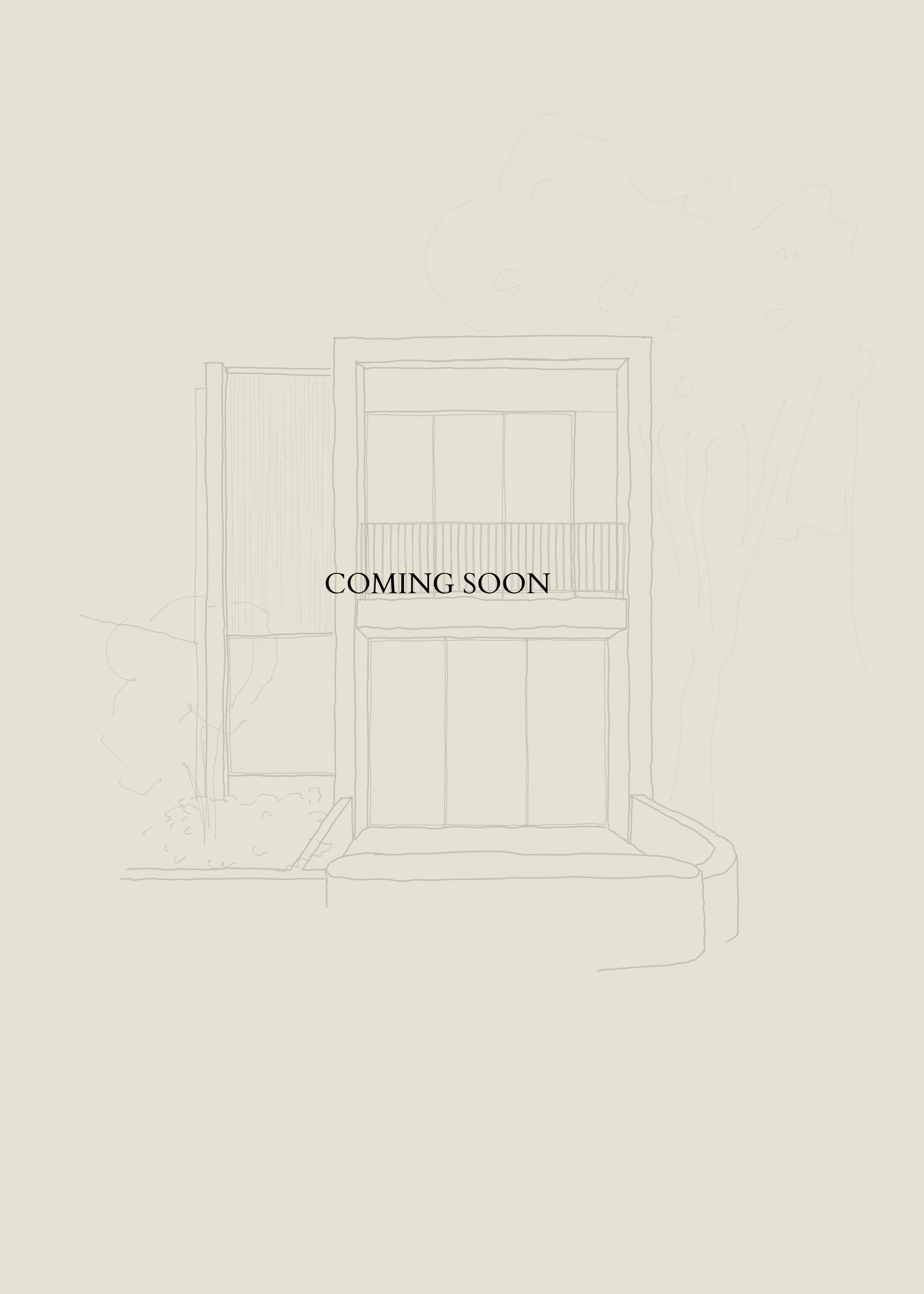 Building with a sign that says 'Coming Soon', front entrance with steps and a small sidewalk, trees and bushes nearby.