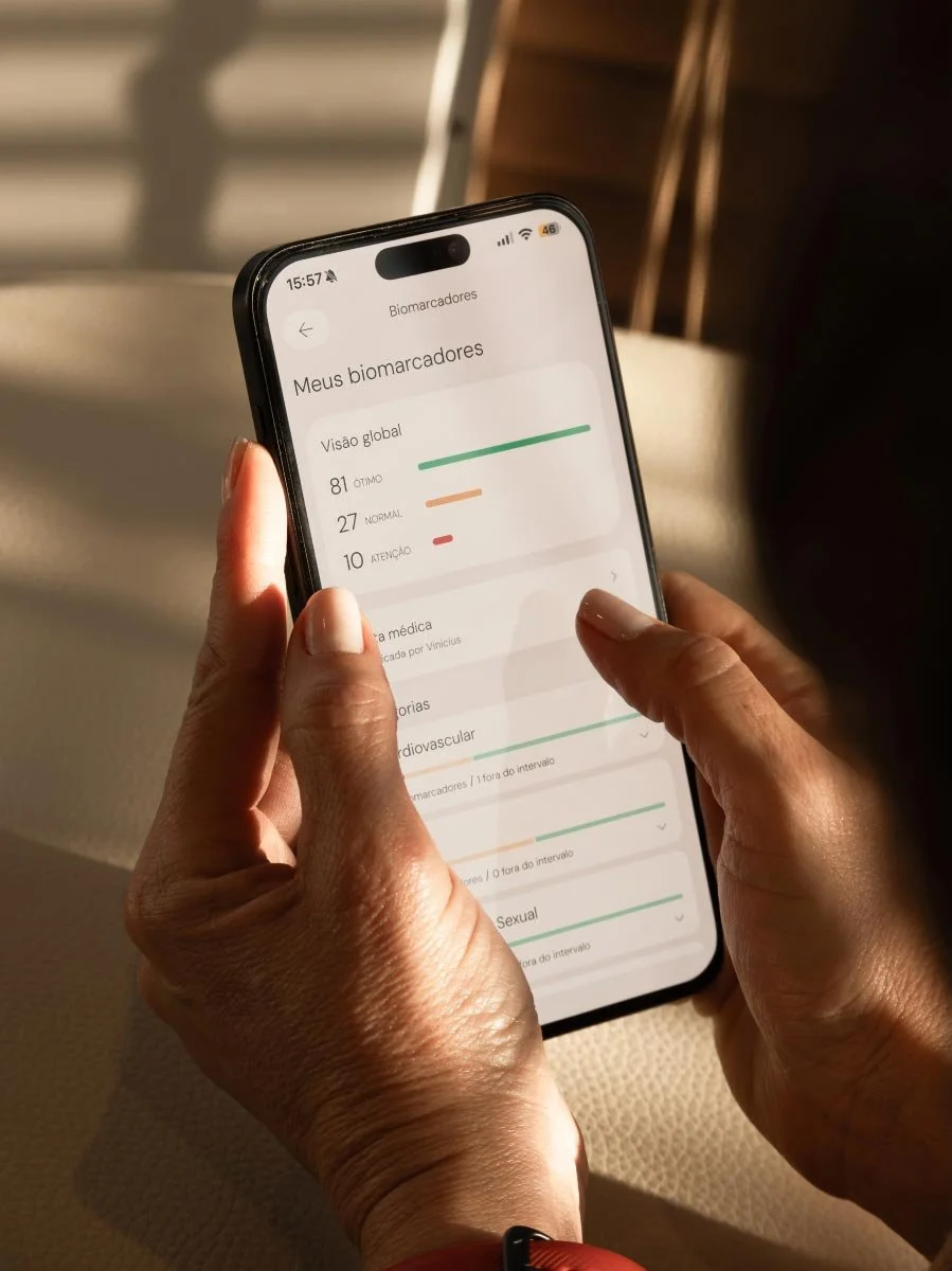 Two woman hands holding a smart phone with a health app. in a warm cozy light