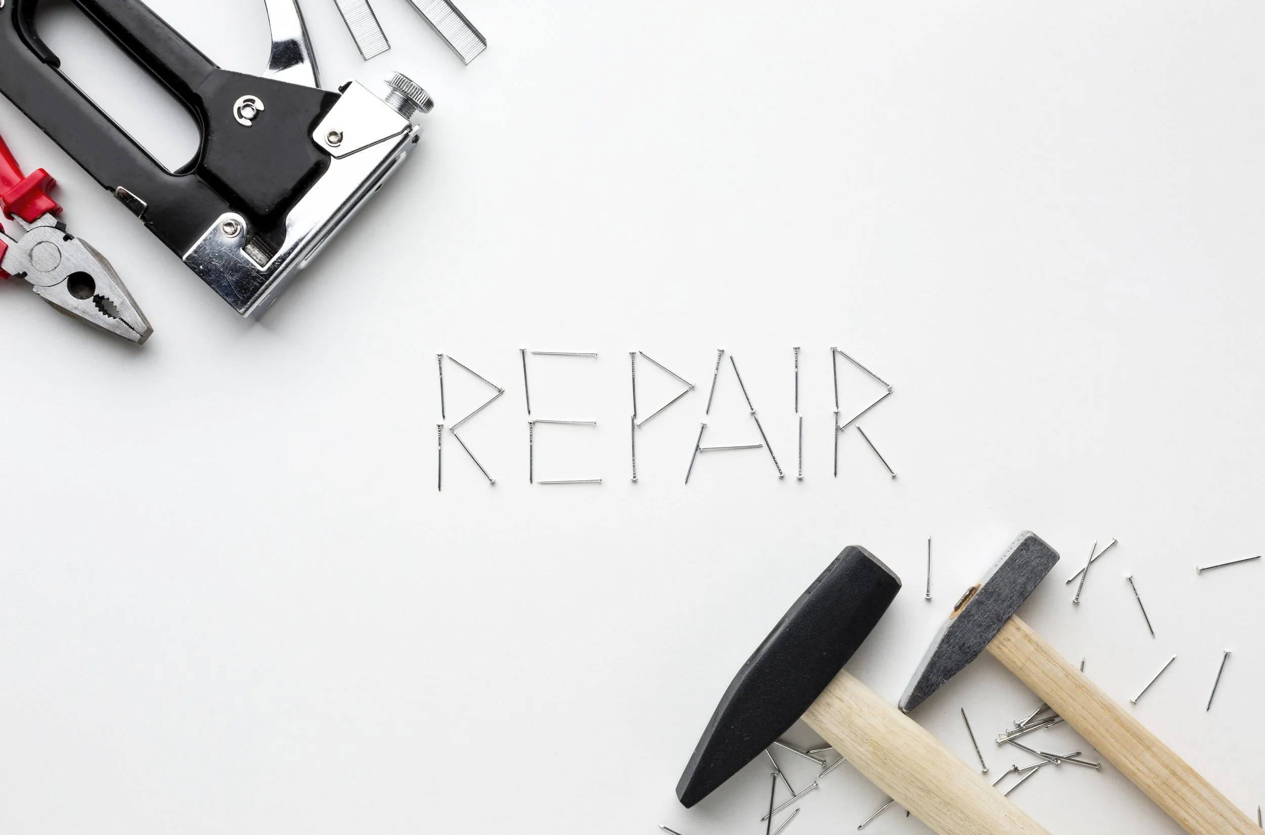 The word repair with tools surrounding the word