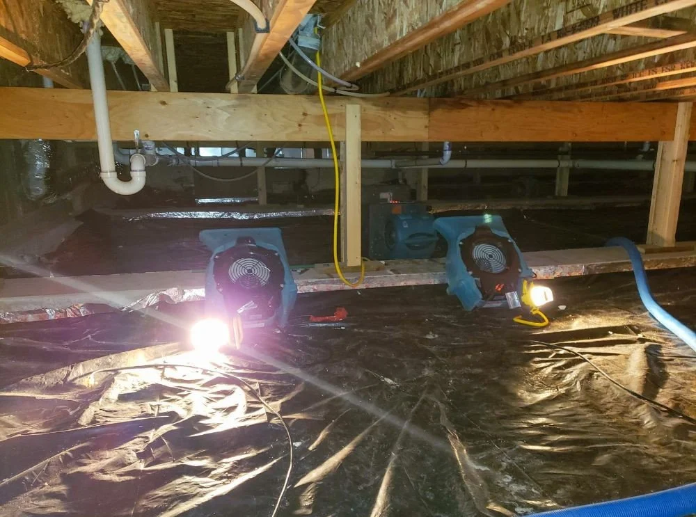 The Provision Property Restoration team drying the crawlspace of a Cumming home after flooding.