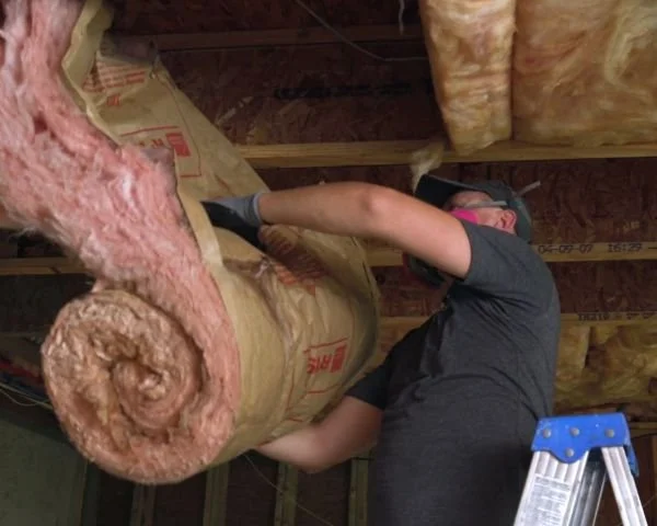 A Provision technician removes damaged insulation from an attic water leak in an Atlanta home.