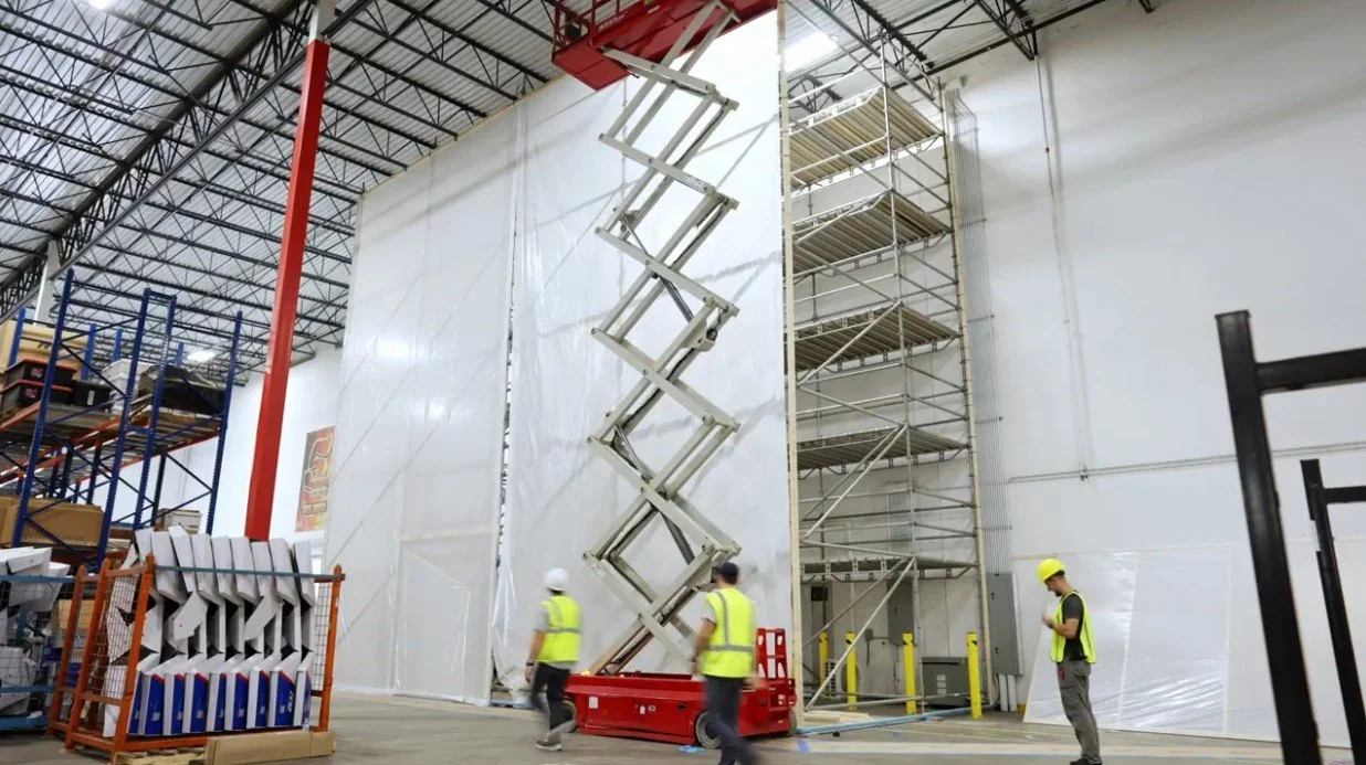 Four Provision Property Restoration employees work on a multi-story containment system at a Gainesville, GA commercial warehouse project.