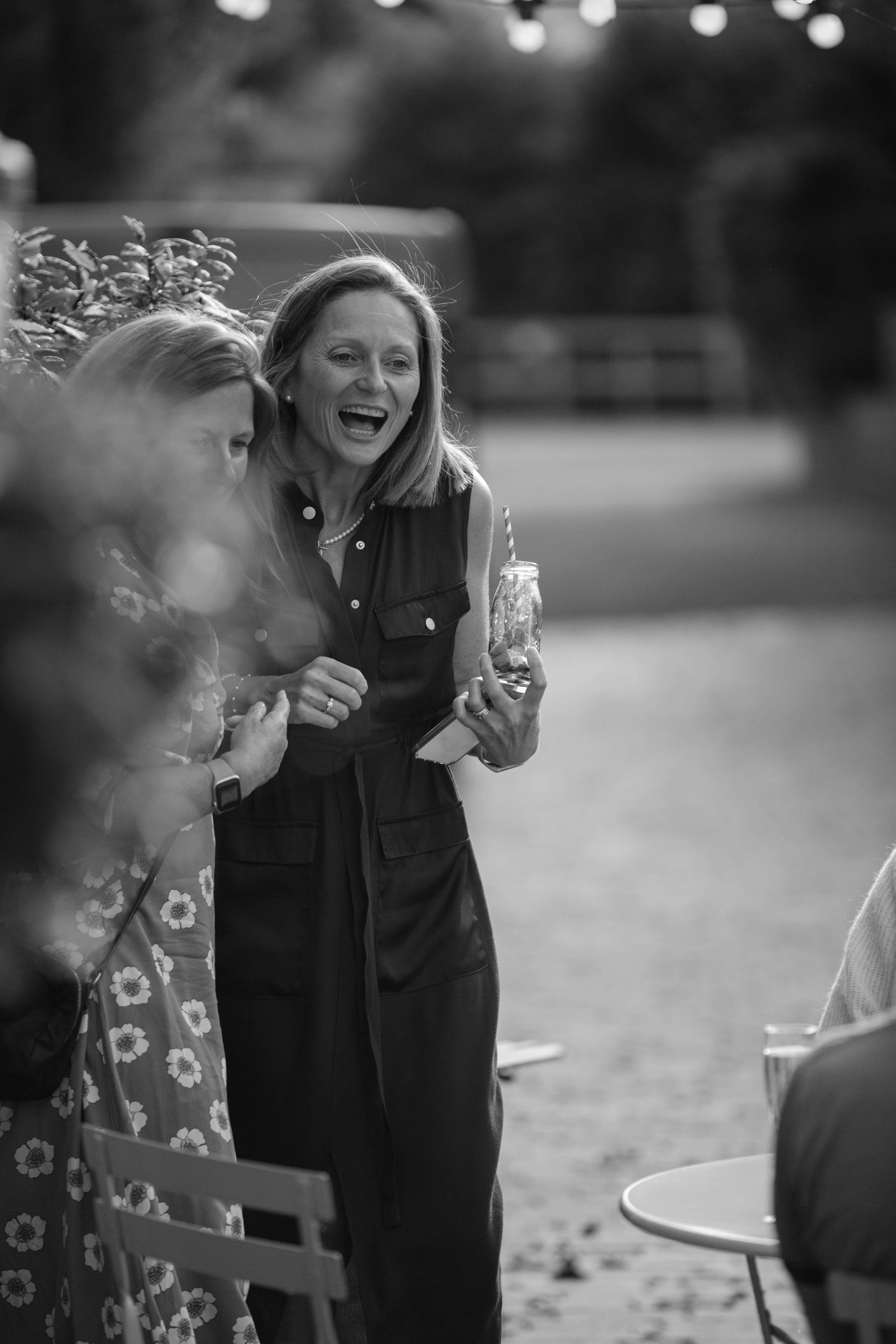 Lady laughing at party with drink.jpg