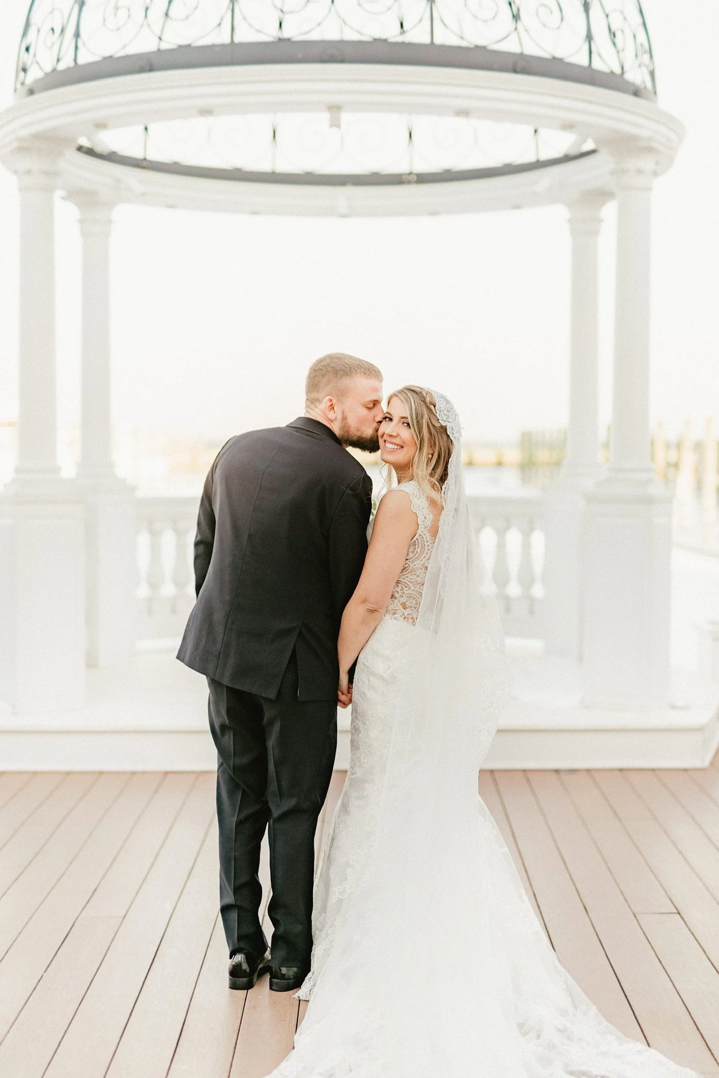 A bride and groom standing under the Wedding Dome, one of Rod 'N' Reel Resort's wedding venues.