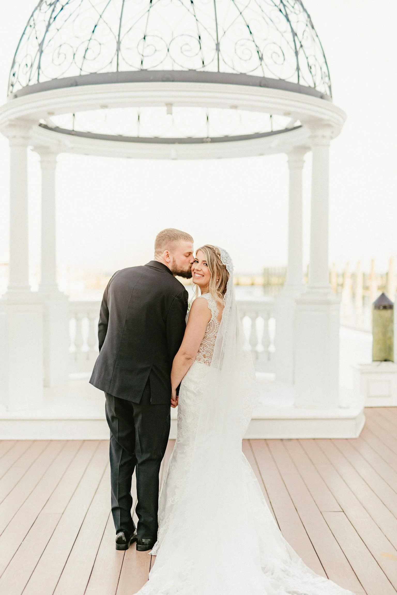 Couple taking photos by Wedding Dome for winter wedding.