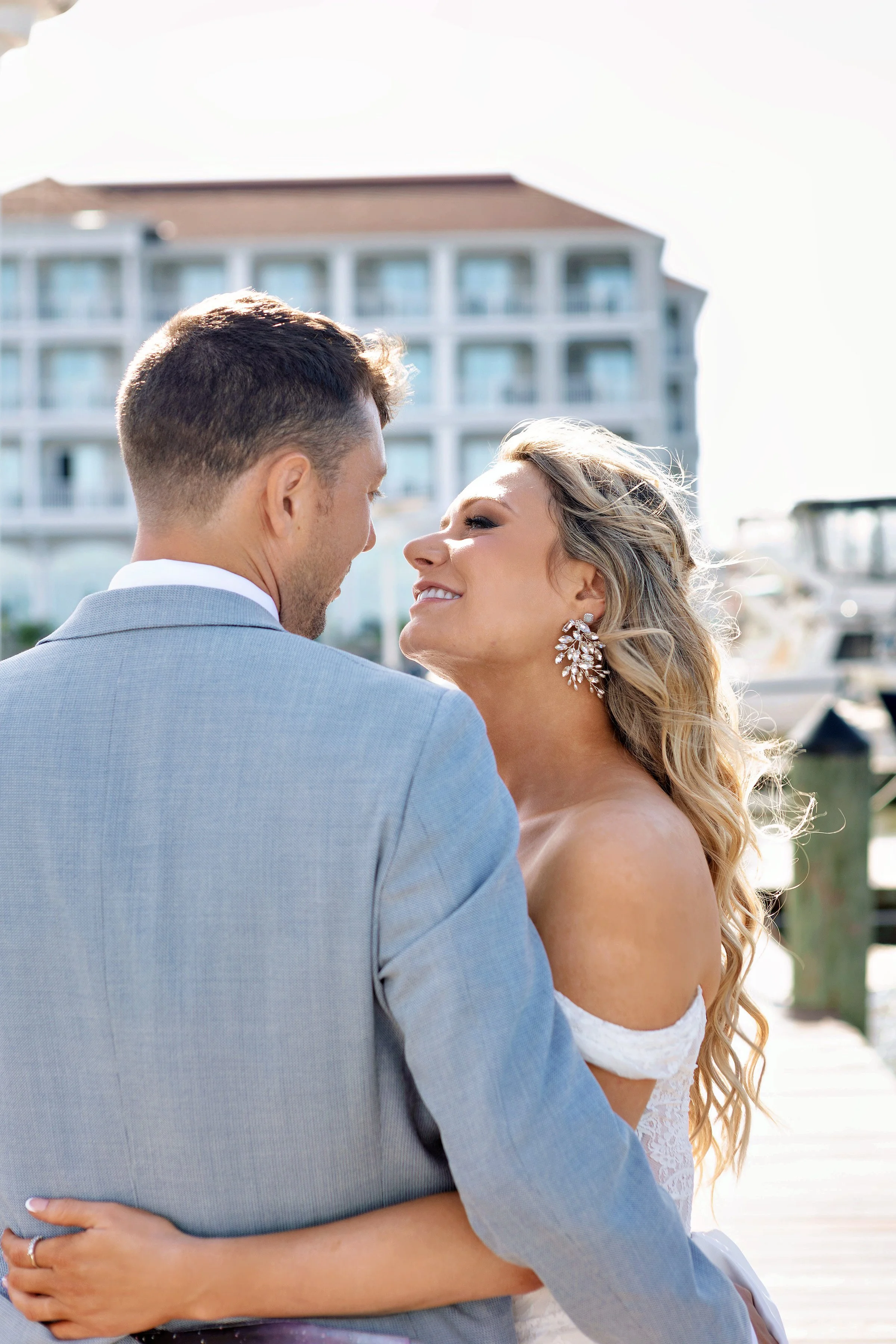 Couple posing by Marina with views of the Resort. 