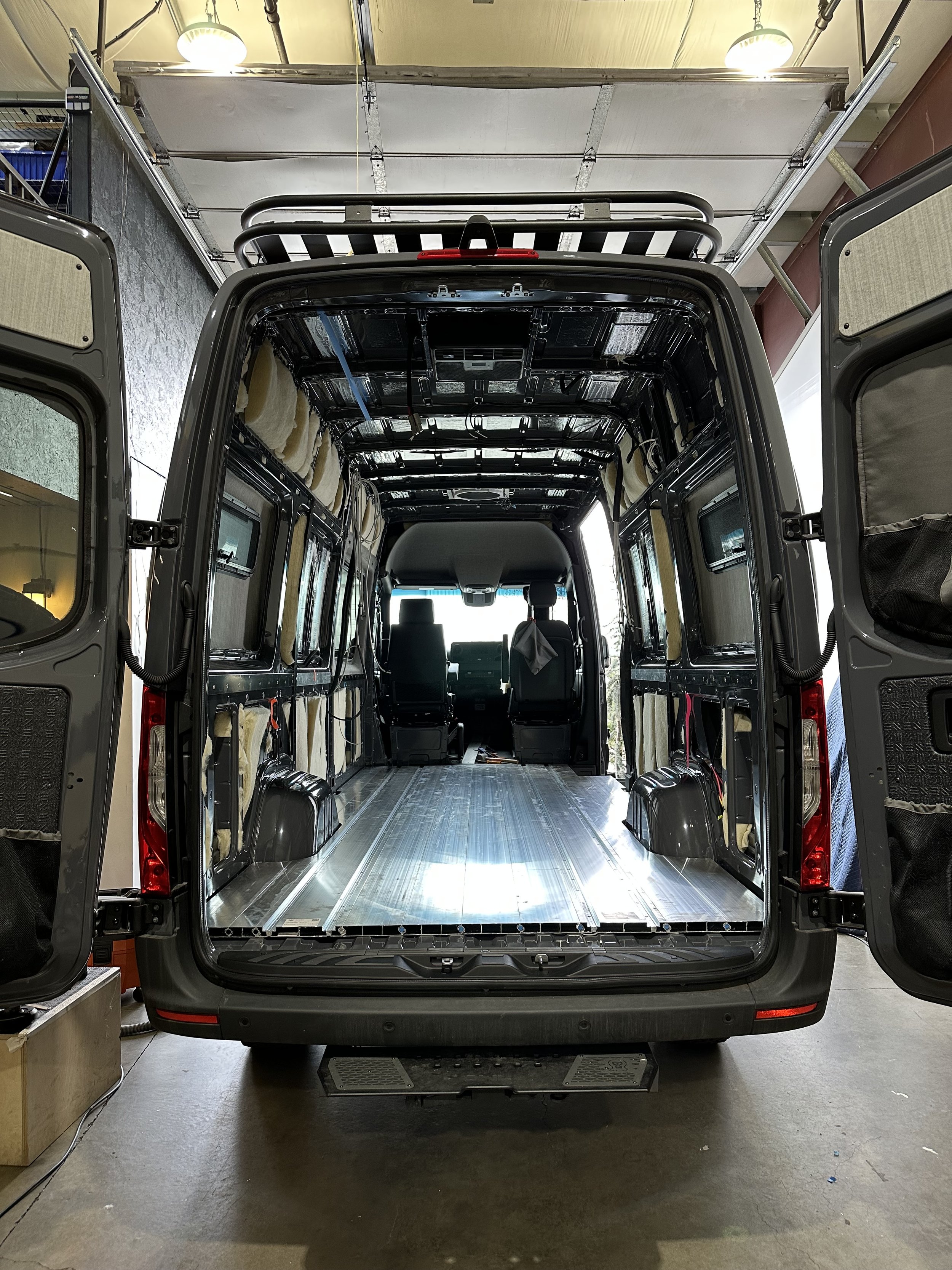 Empty van undergoing build-out with recent SmartFloor prominently displayed