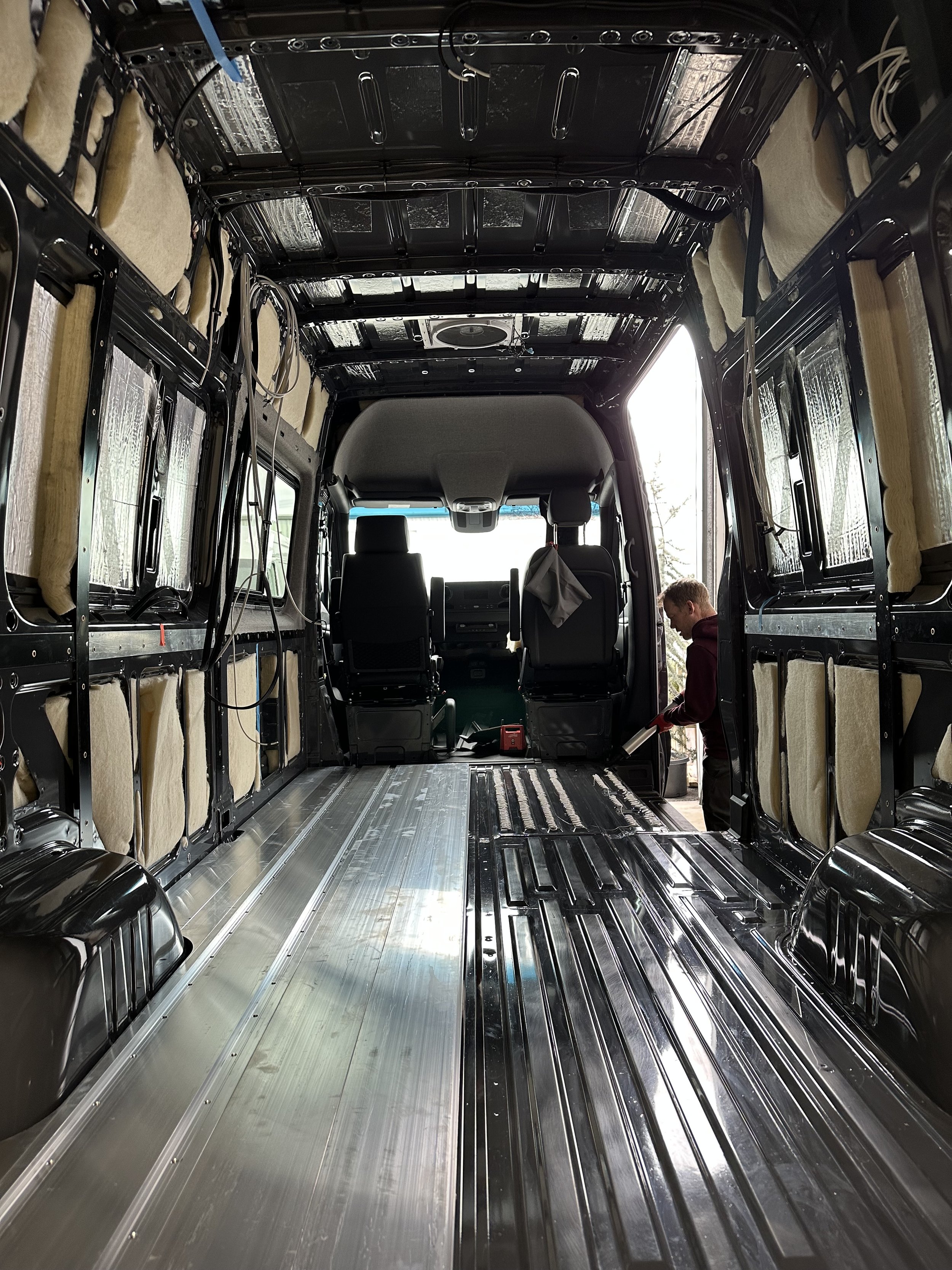 Empty van undergoing build-out with recent SmartFloor prominently displayed