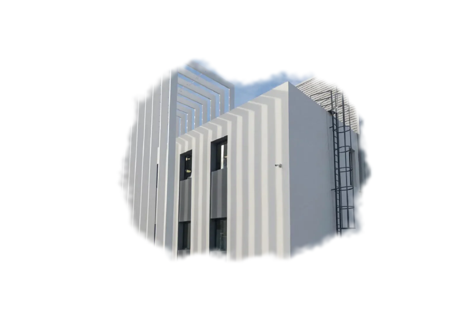 Industrial building with a screen of tall white fins and an outdoor ladder