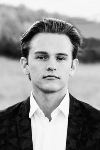 Black and white portrait of a young man outdoors