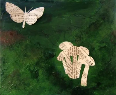 Two paper cutouts of a butterfly and a rabbit with printed text on green painted background.