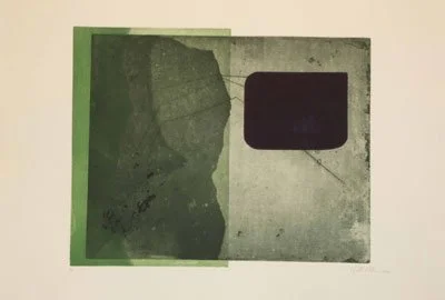 Close-up of a card with a green and black design, featuring an embossed or raised black rectangle on the right side.
