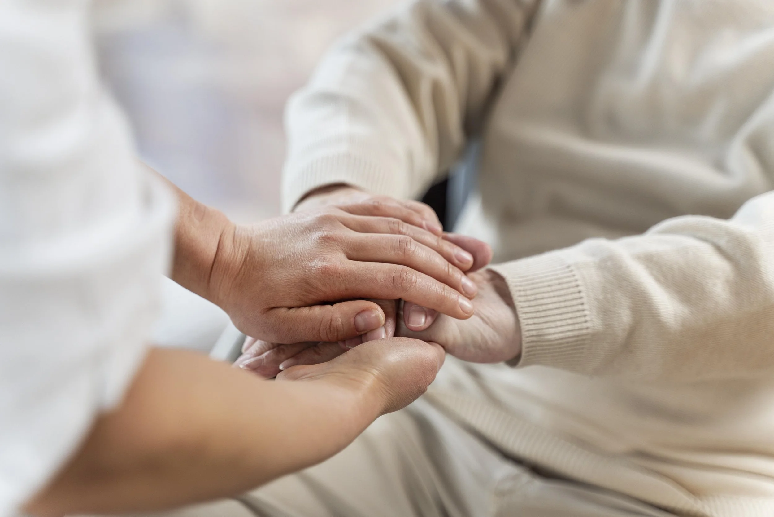 Multiple hands touching each other, suggesting a gesture of support or teamwork.