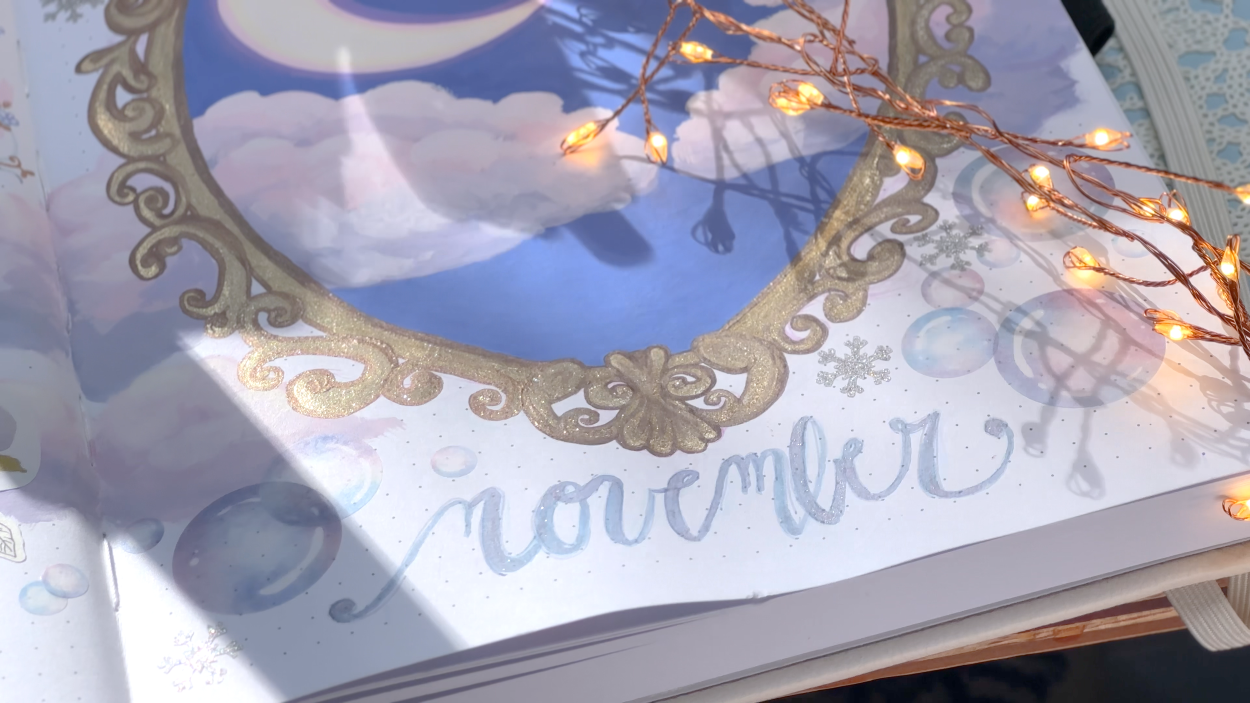 November 2025 journal art, rococo style frame around pastel sky; gouache, watercolor, and ink 