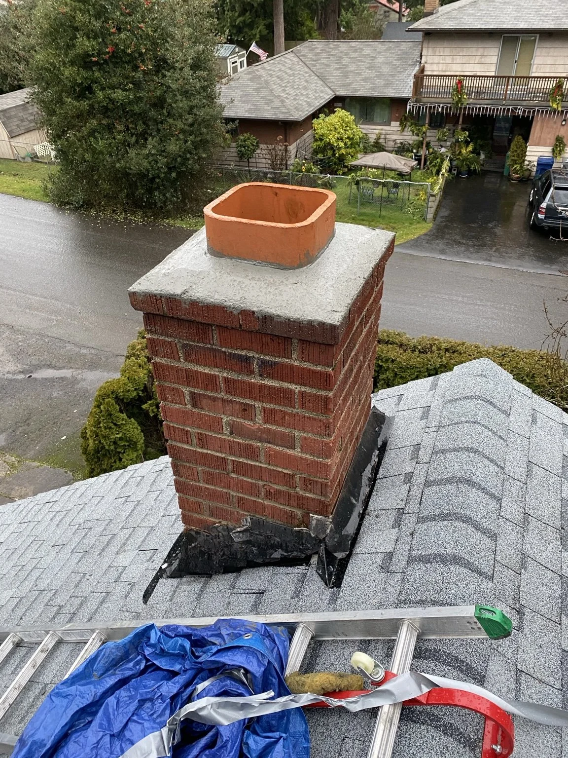 Brick chimney after mortar repair and installation of a new chimney crown and flue tile.