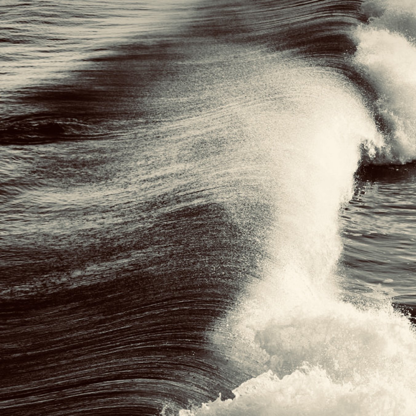 Sepia-toned image of a crashing ocean wave