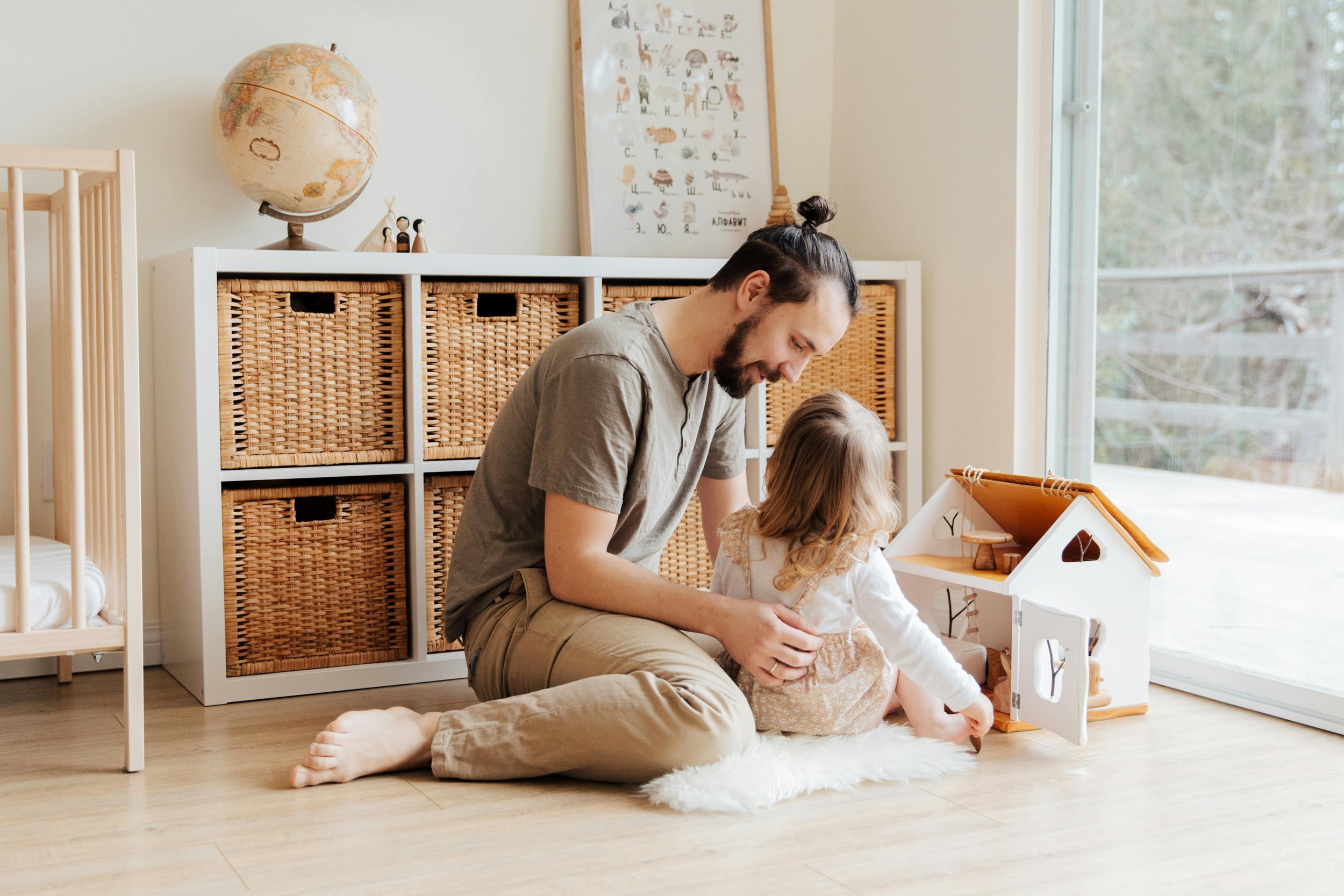 father and daughter playing with dollhouse