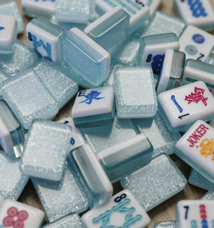 Close-up of pile of various Mah Jongg Maven tiles, including bamboo, characters, and winds.