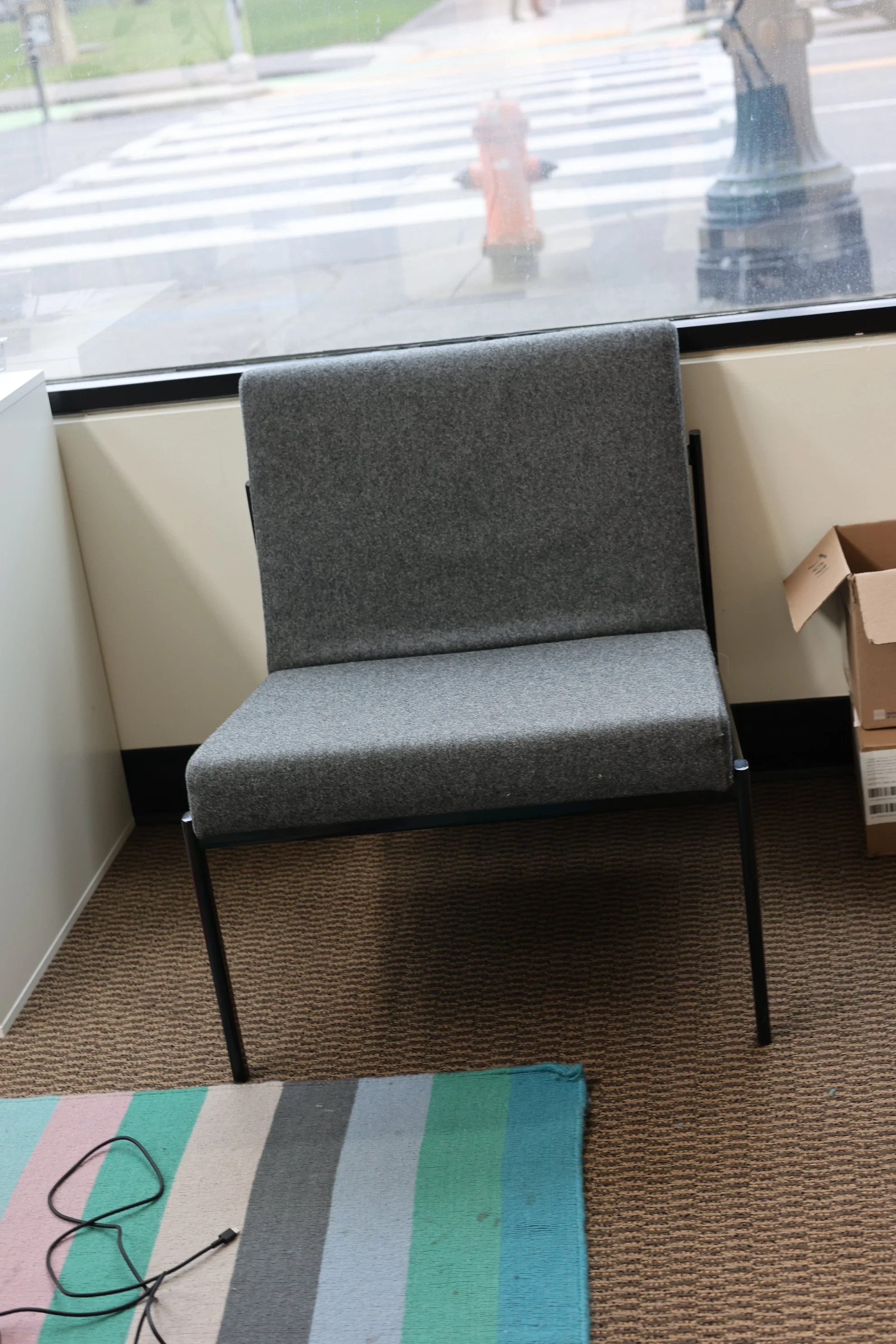 Grey Cushioned Chair with Black Metal Legs