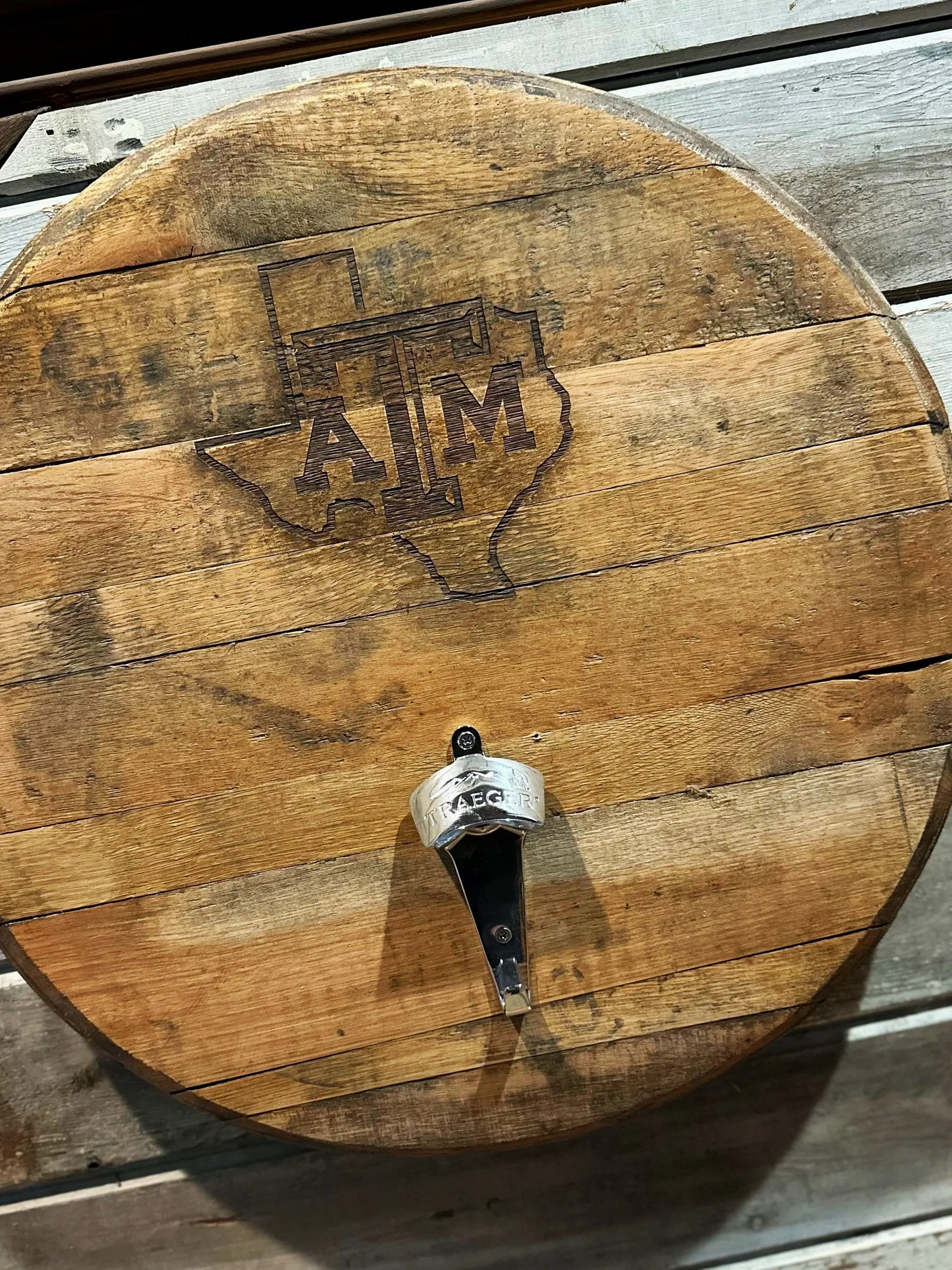 Wooden barrel with vintage logo of St. Augustine Distillery Co, labeled Bourbon Whiskey, in a store display.