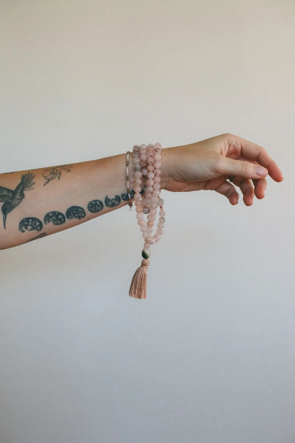 pink mala bracelet on wrist